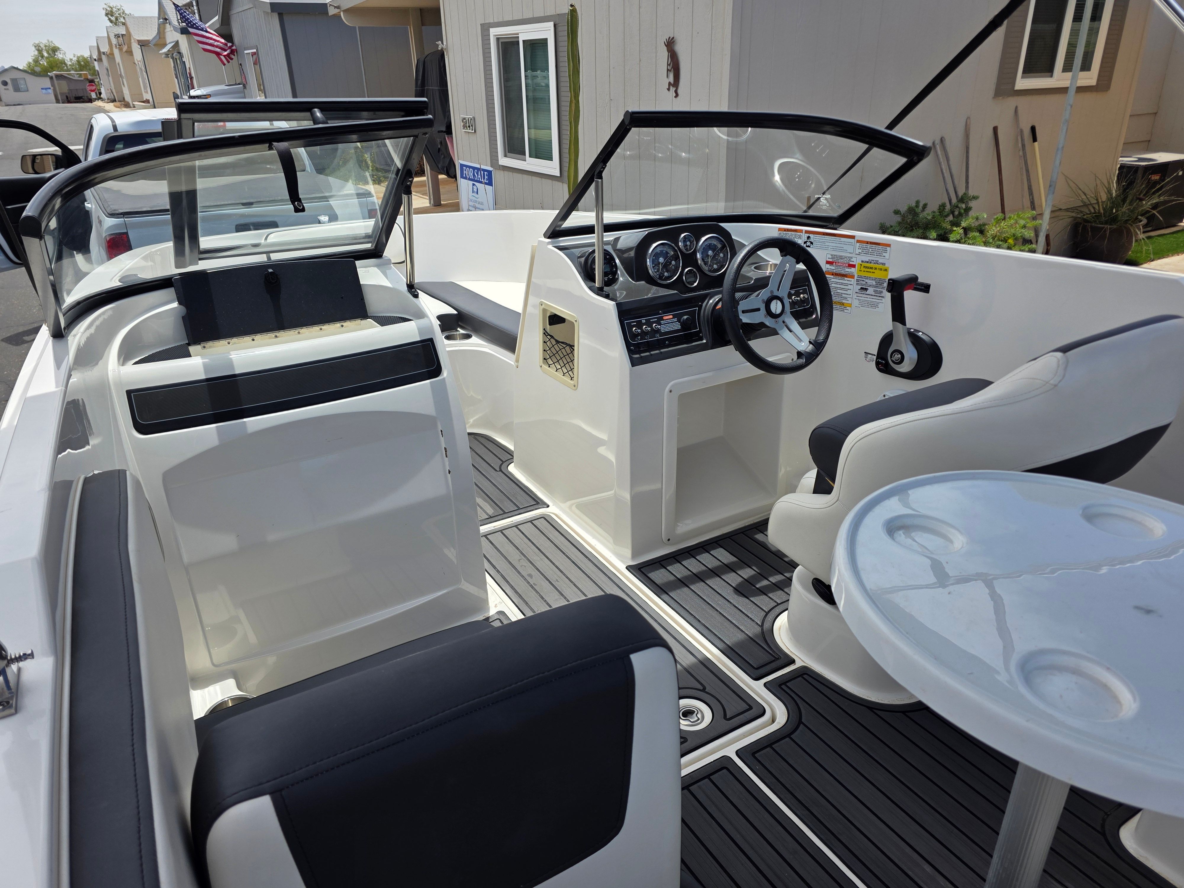 Interior view of a 2021 Bayliner VR4 Bowrider I/O with steering wheel and seating.