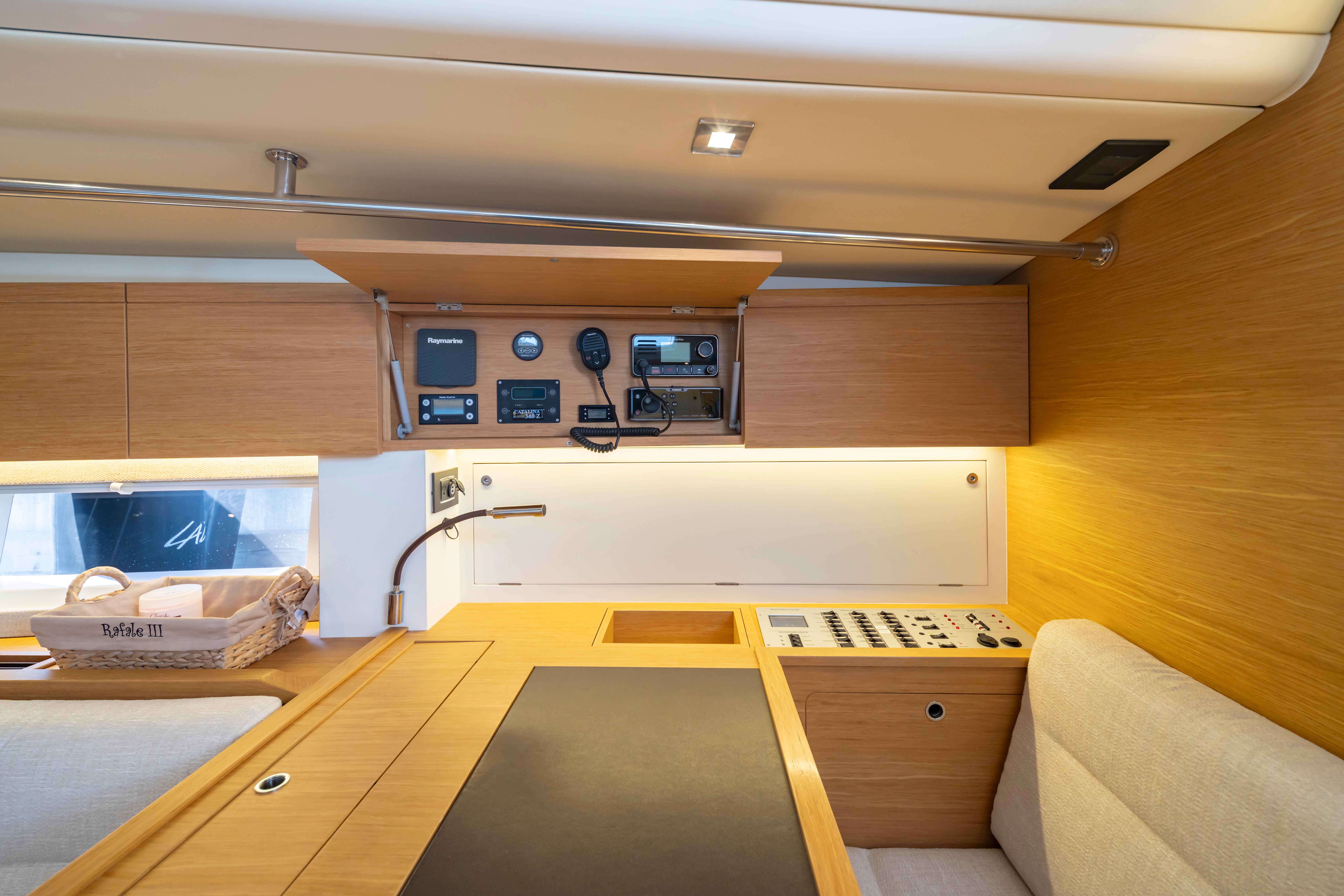 Interior of 2016 Grand Soleil 58 yacht with navigation equipment and wooden cabinetry.