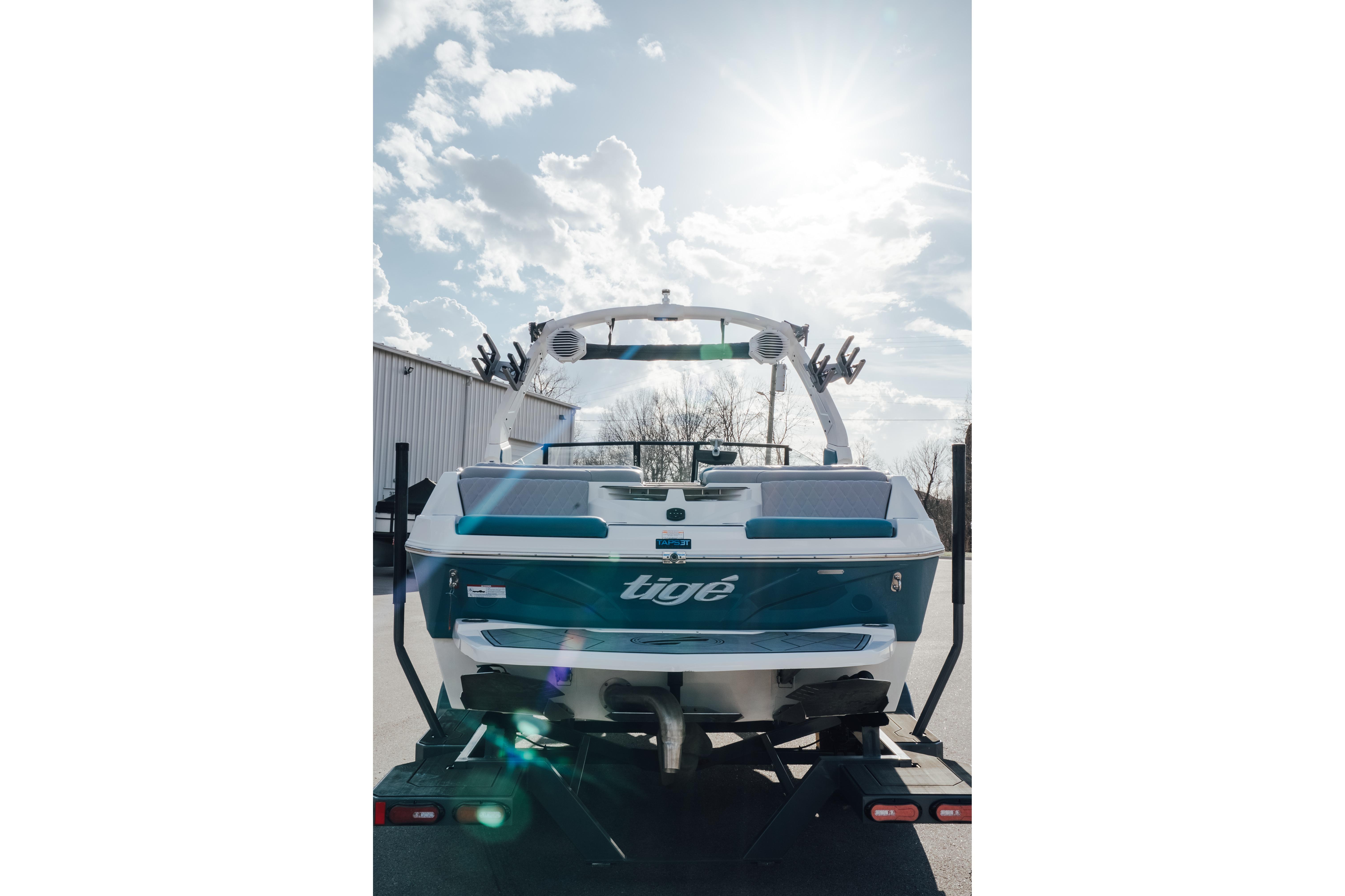 2023 Tigé Z1 boat on trailer under sunny sky.