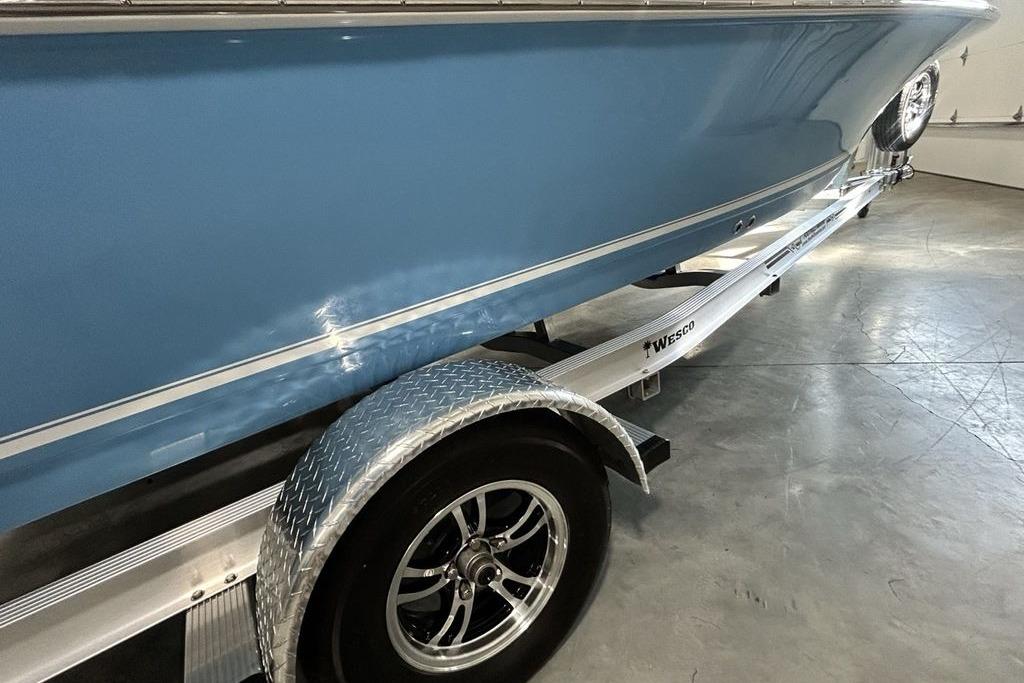 2026 Tidewater 1910 Bay Max boat on trailer, featuring sleek blue hull design.