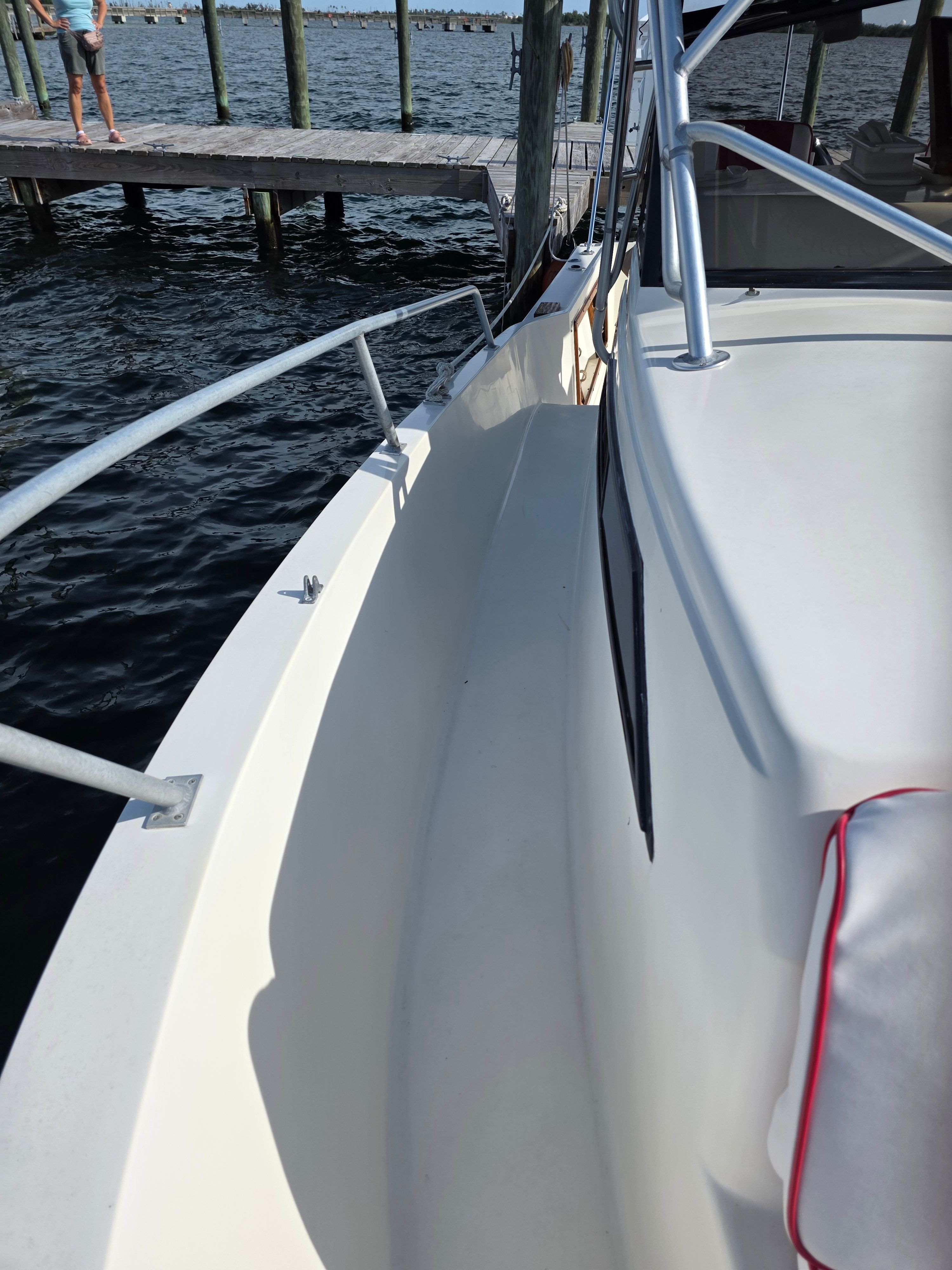 1987 Mako 248 WAC boat at dock, side view.