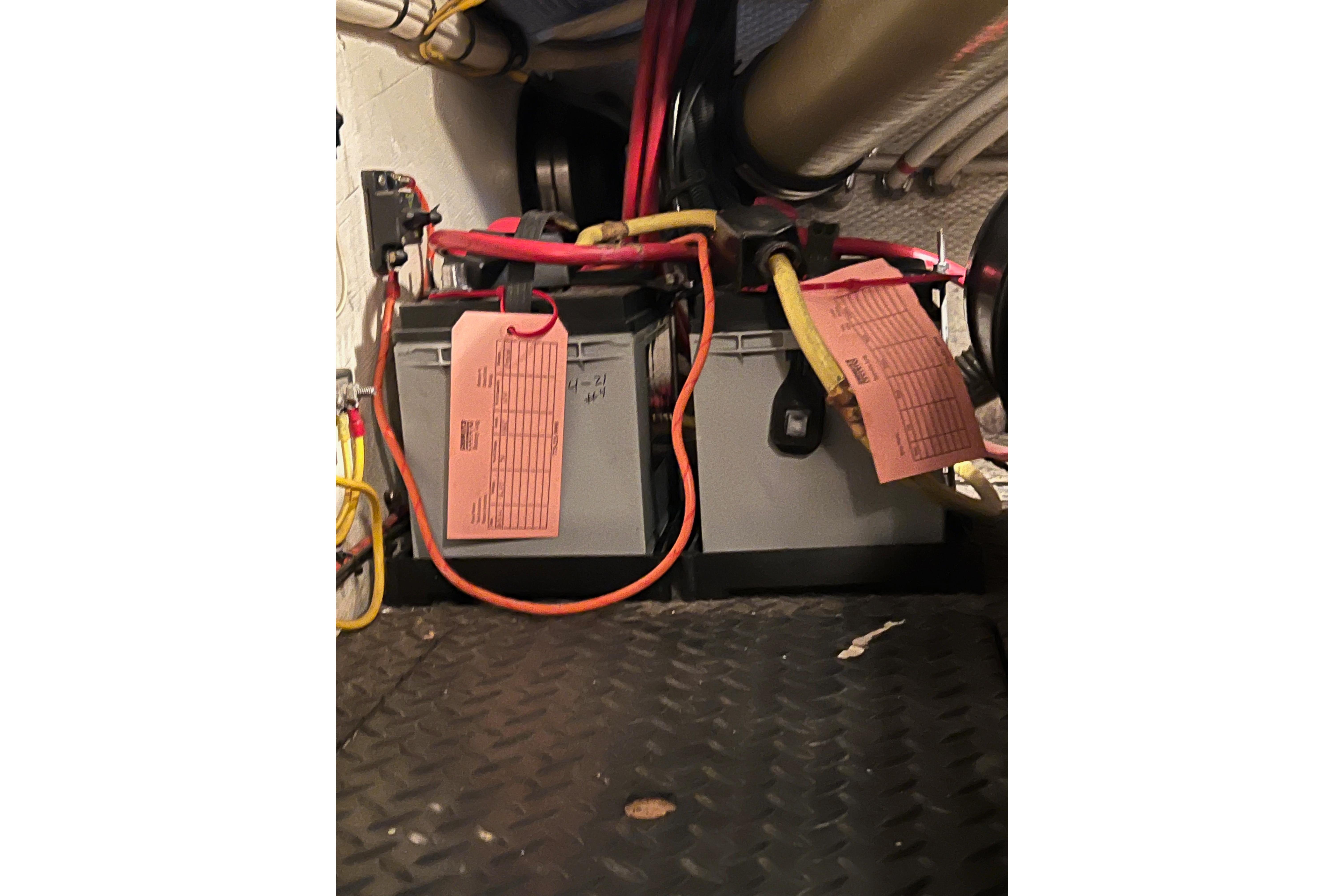 Battery compartment of a 2006 Silverton 38 Sport Bridge with labeled cables.