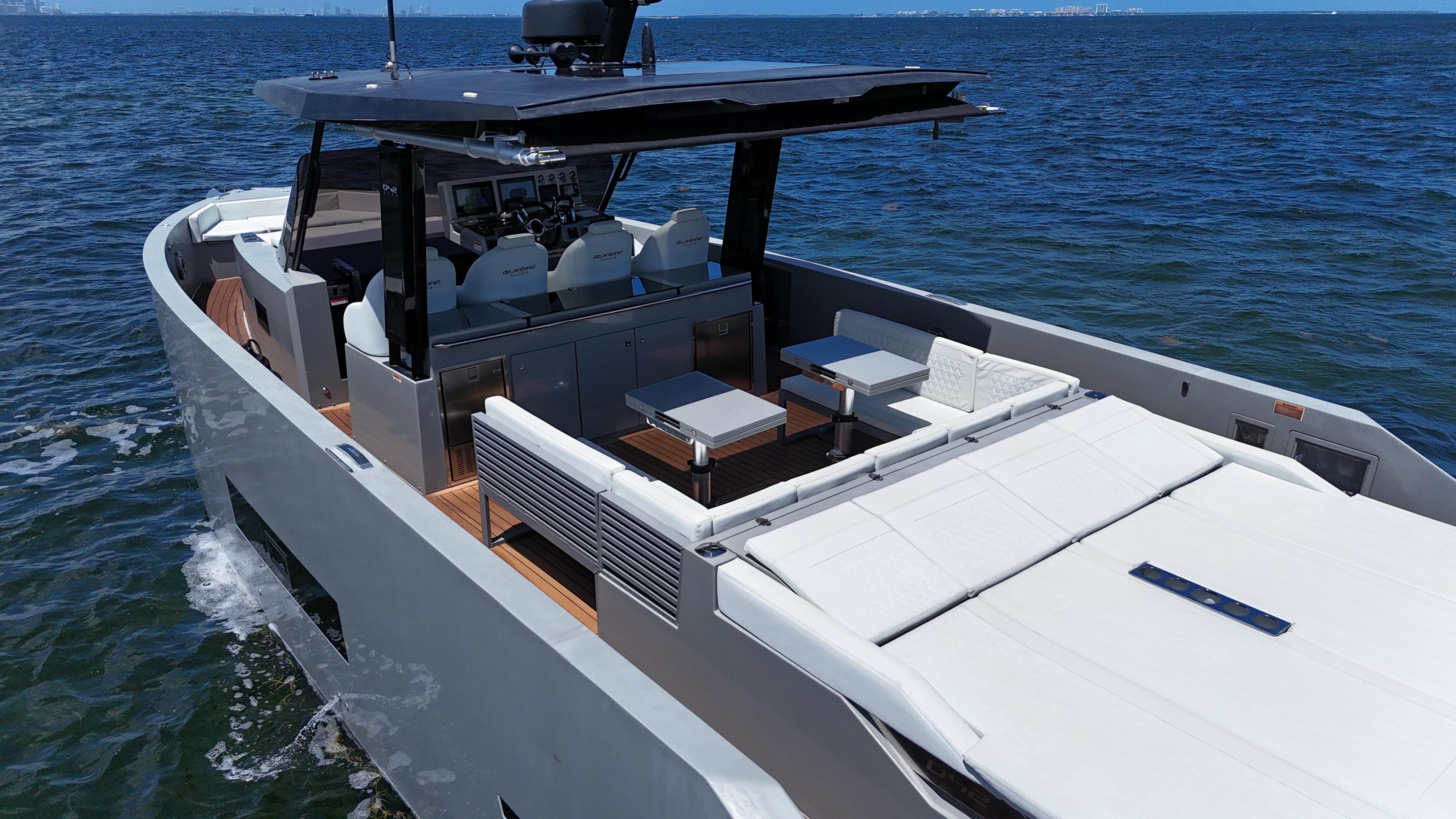Luxury 2021 De Antonio Yachts D42 cruising on open water, featuring sleek design and spacious deck.