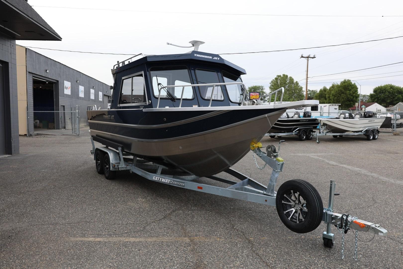 2026 Thunder Jet 24 Alexis Pro boat on trailer, parked outdoors.