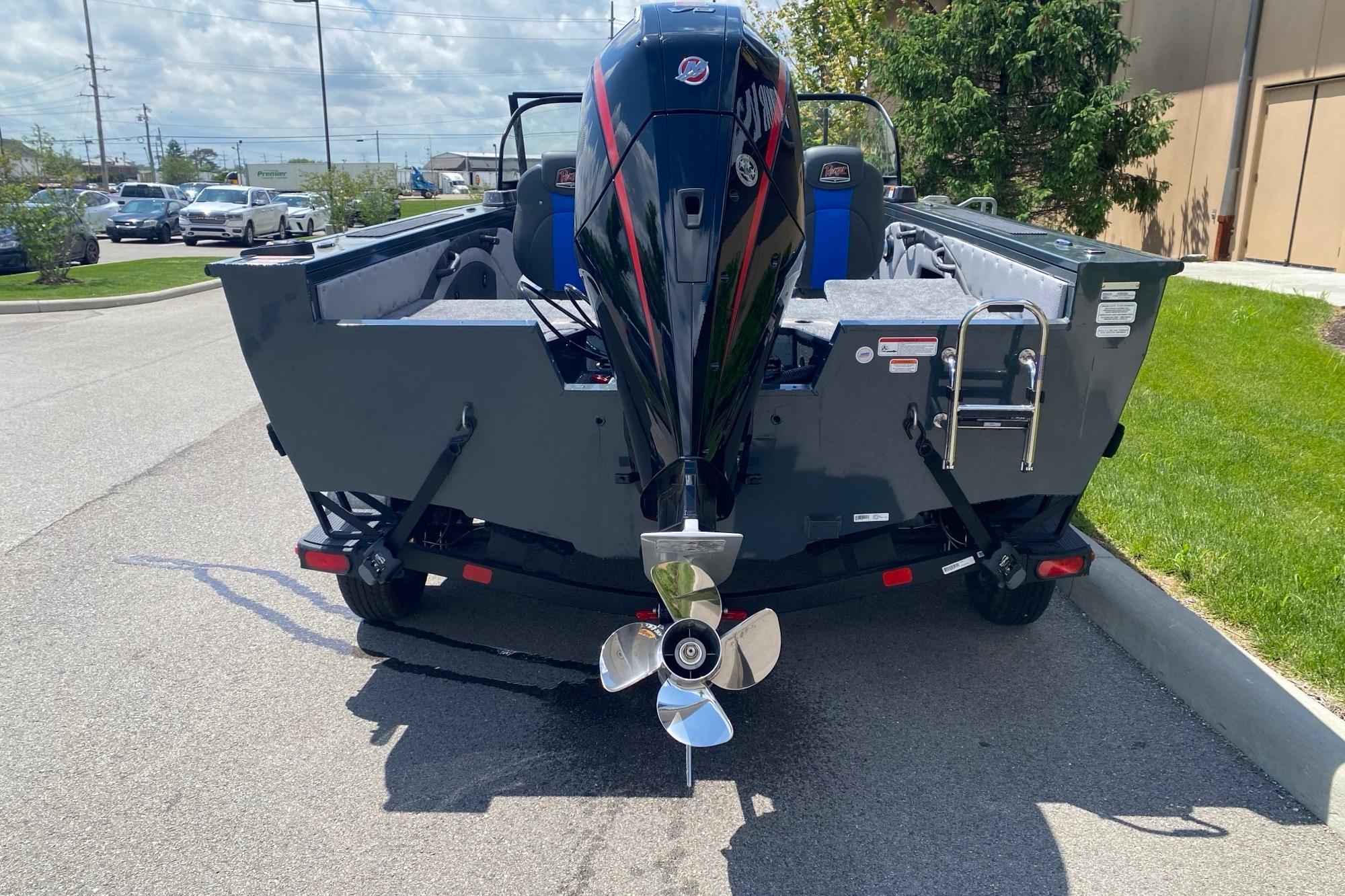 2026 Ranger VX1888 WT boat with powerful outboard motor, parked on a sunny street.