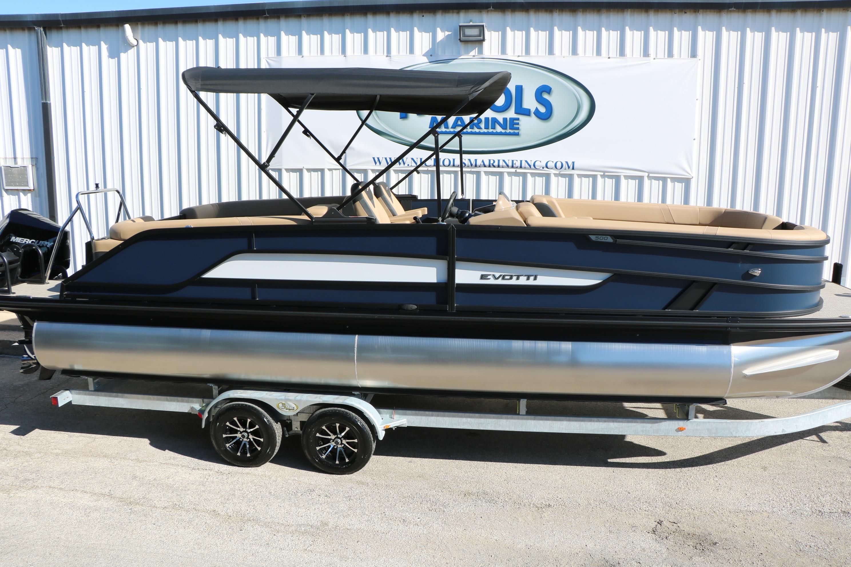 2026 Evotti 525 QL Tri-Toon boat with canopy on trailer, side view.