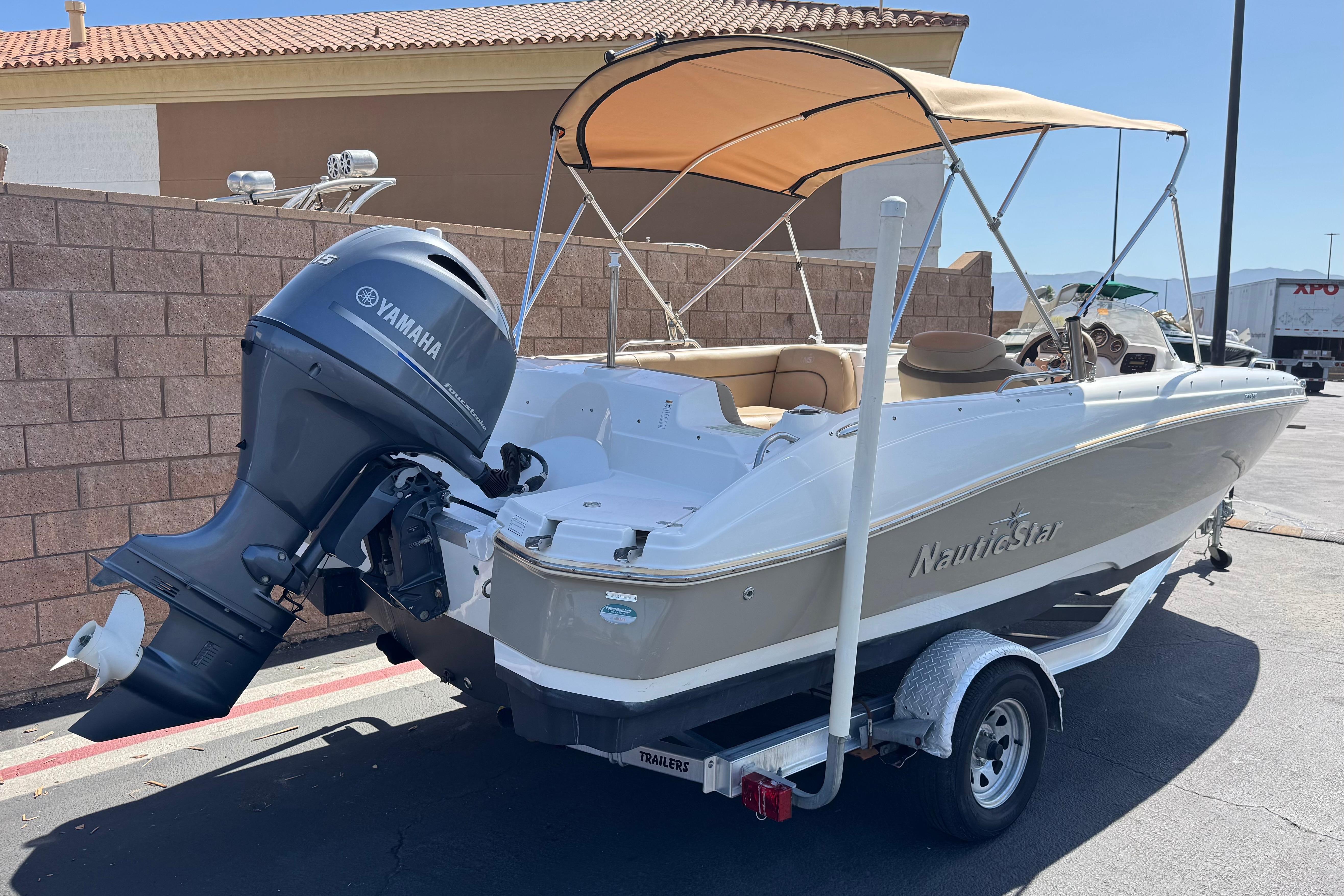 2020 NauticStar 203 SC boat with Yamaha outboard motor, parked on a trailer.