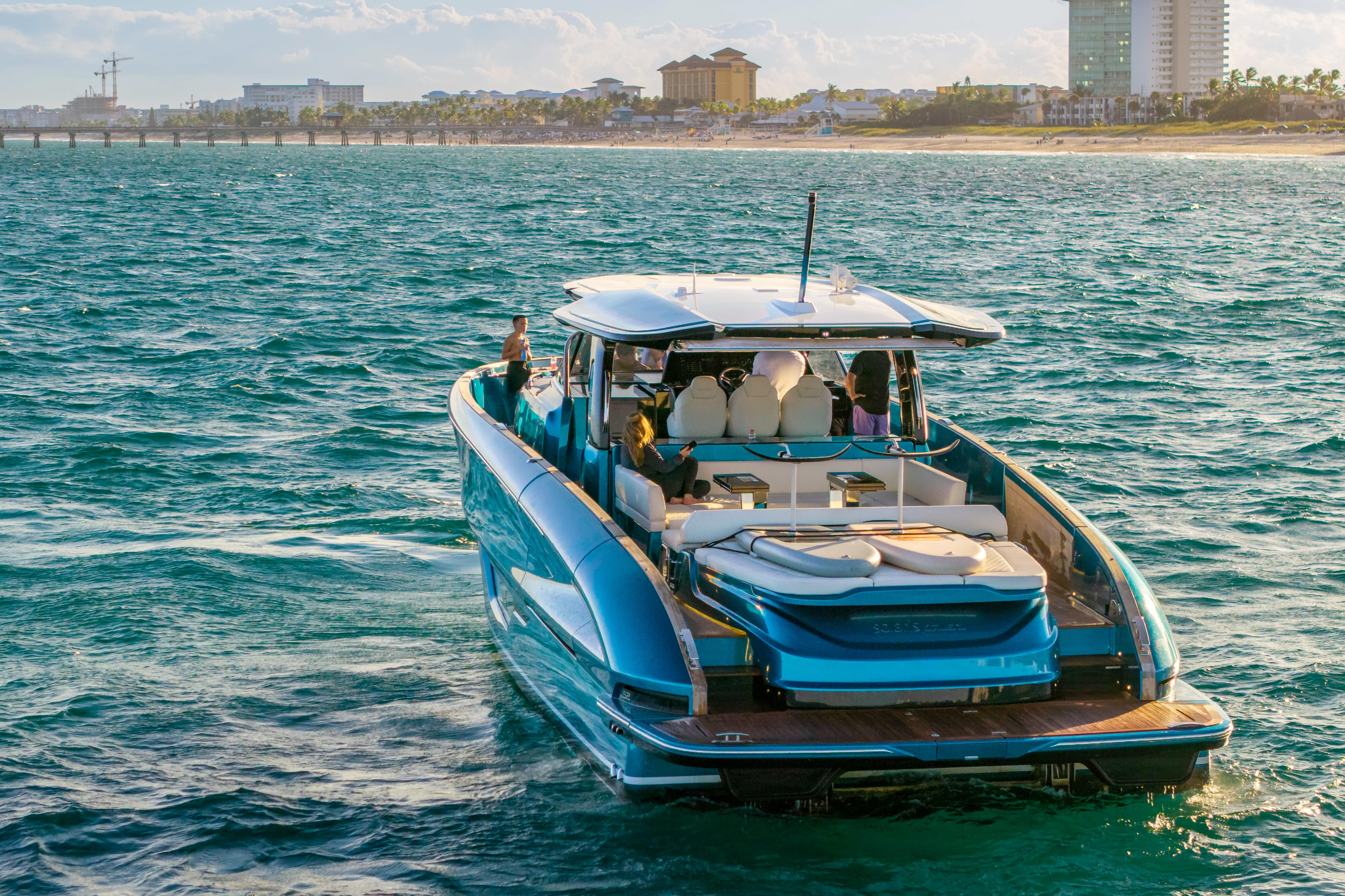 2024 Solaris Power 52 Open yacht cruising near a coastal cityscape.