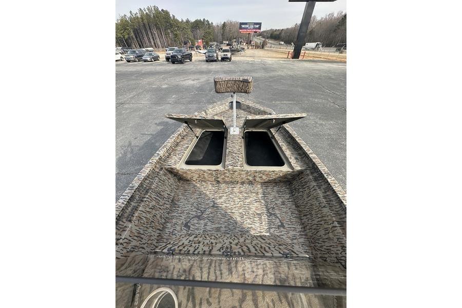 2026 Xpress H190B Bay boat with open storage compartments, parked outdoors.