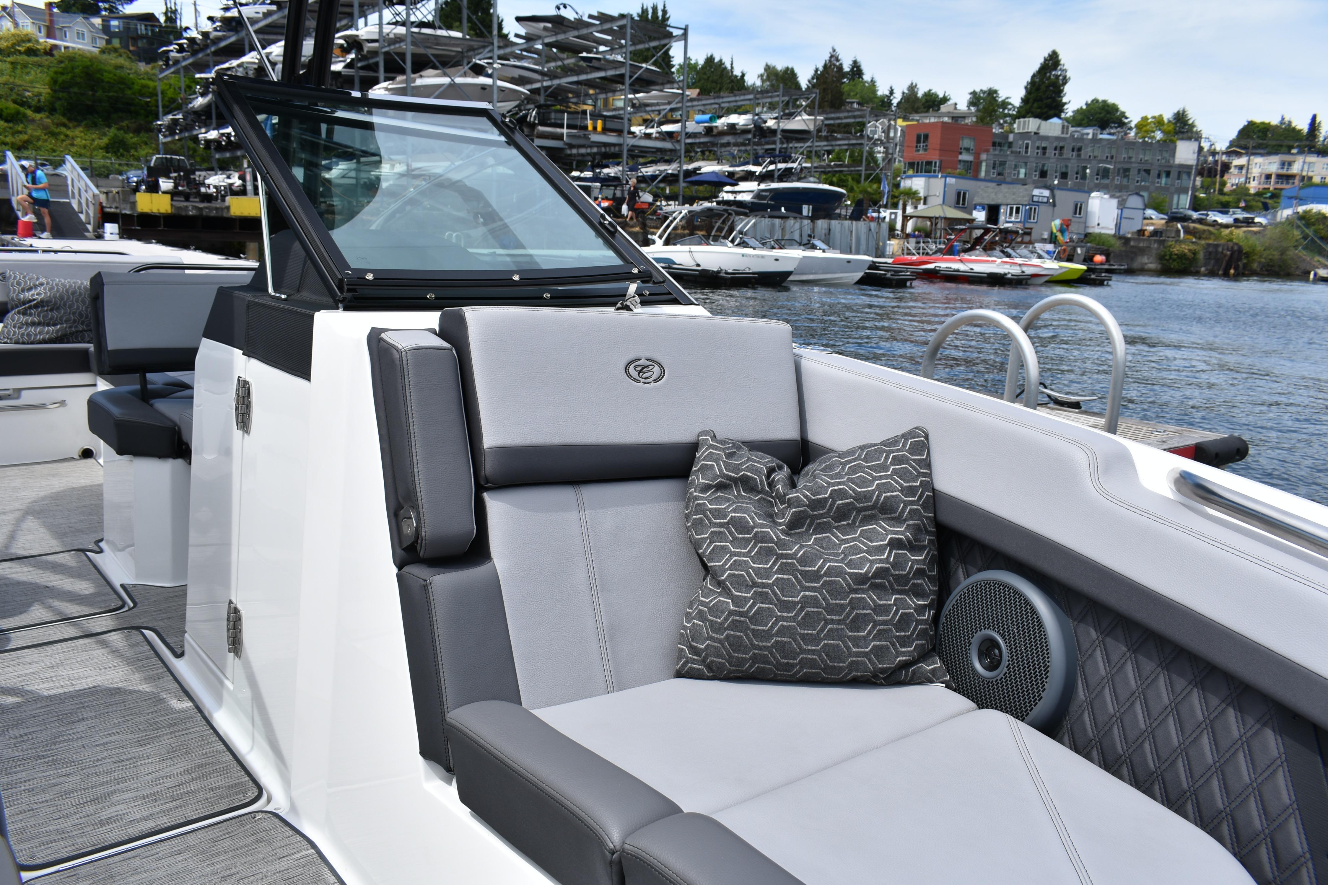 2023 Cobalt R8 boat interior with gray seating and decorative pillow by the water.