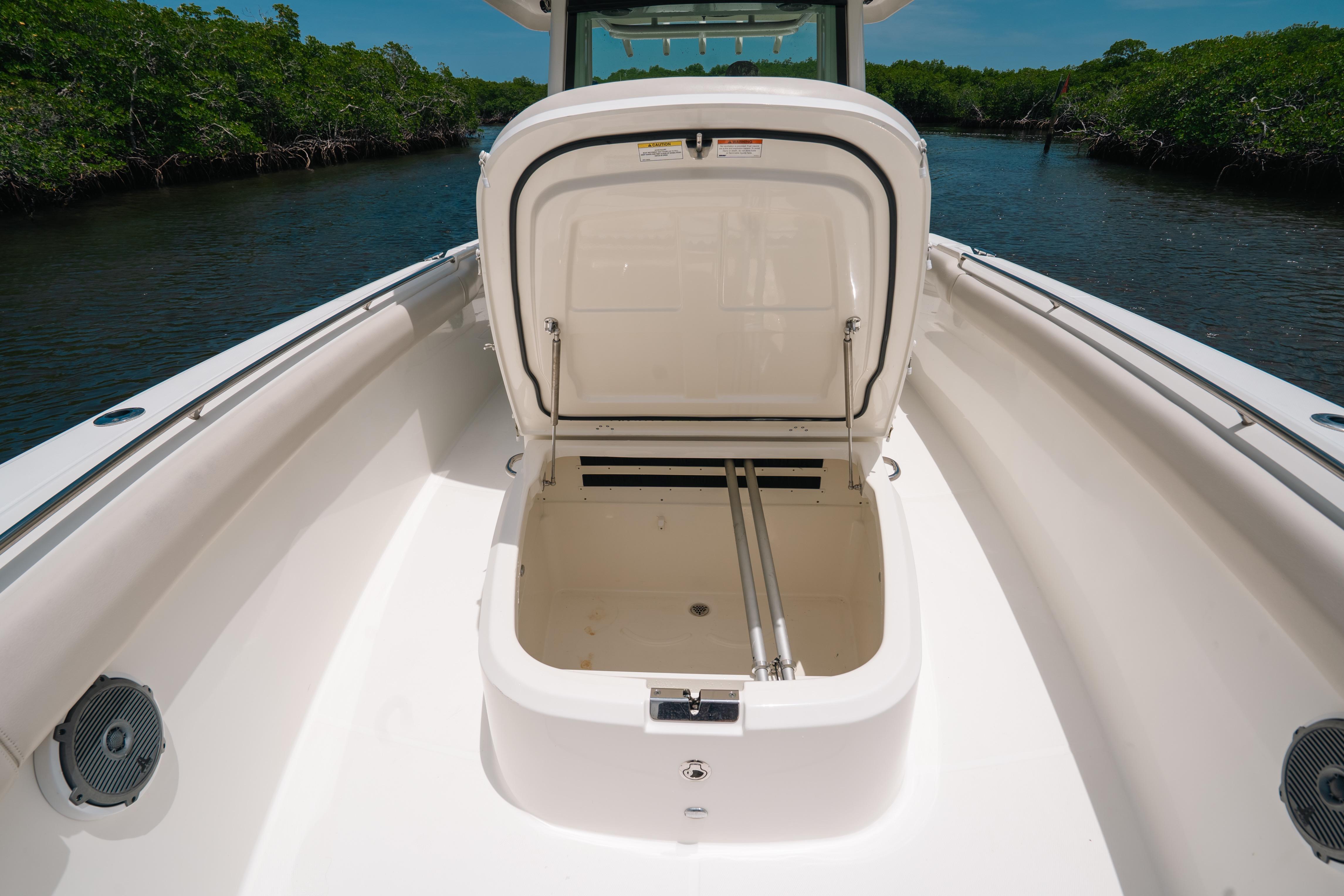 2019 Boston Whaler 330 Outrage boat with open storage compartment on deck.