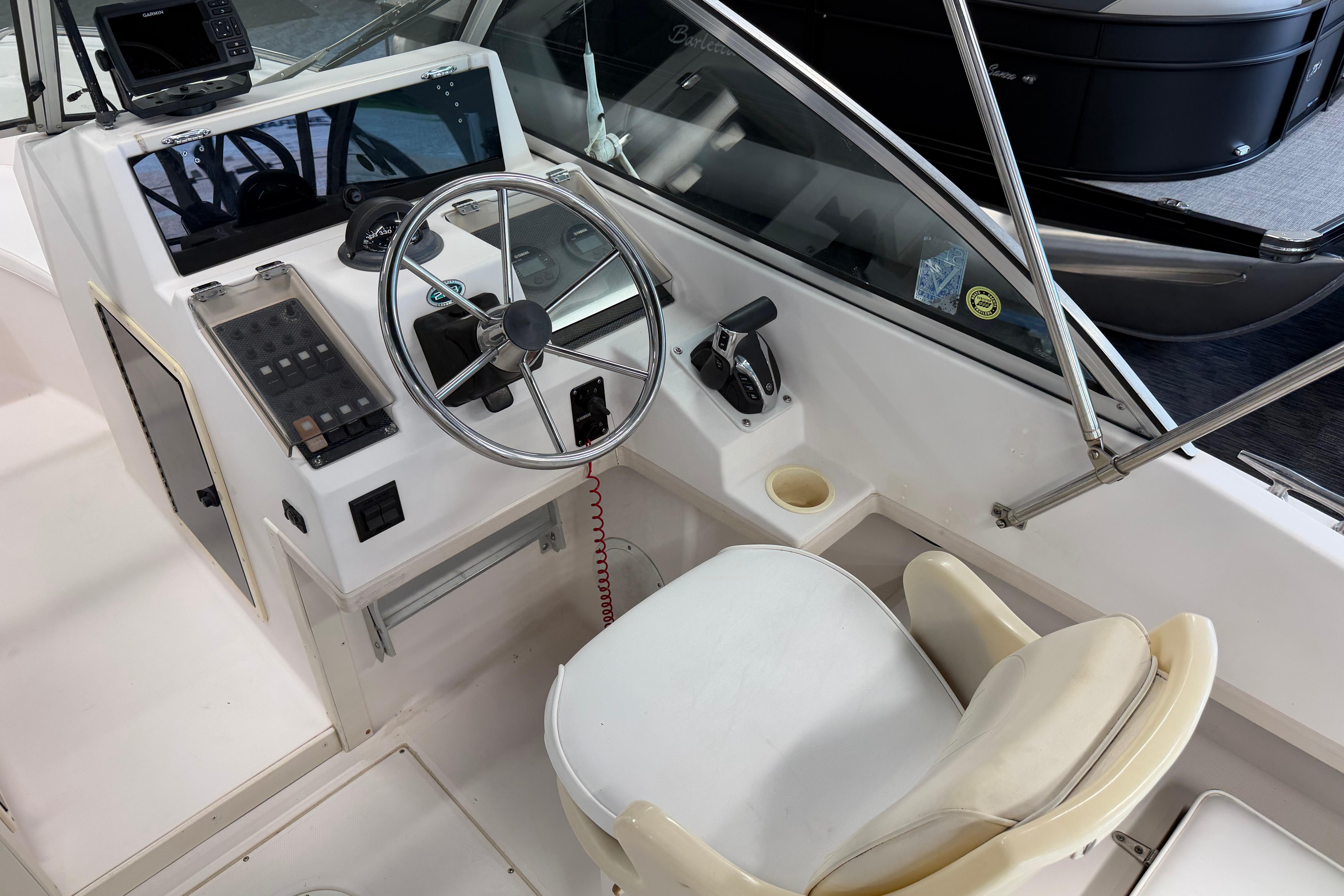 2001 Grady-White Tournament 223 boat cockpit with steering wheel and control panel.