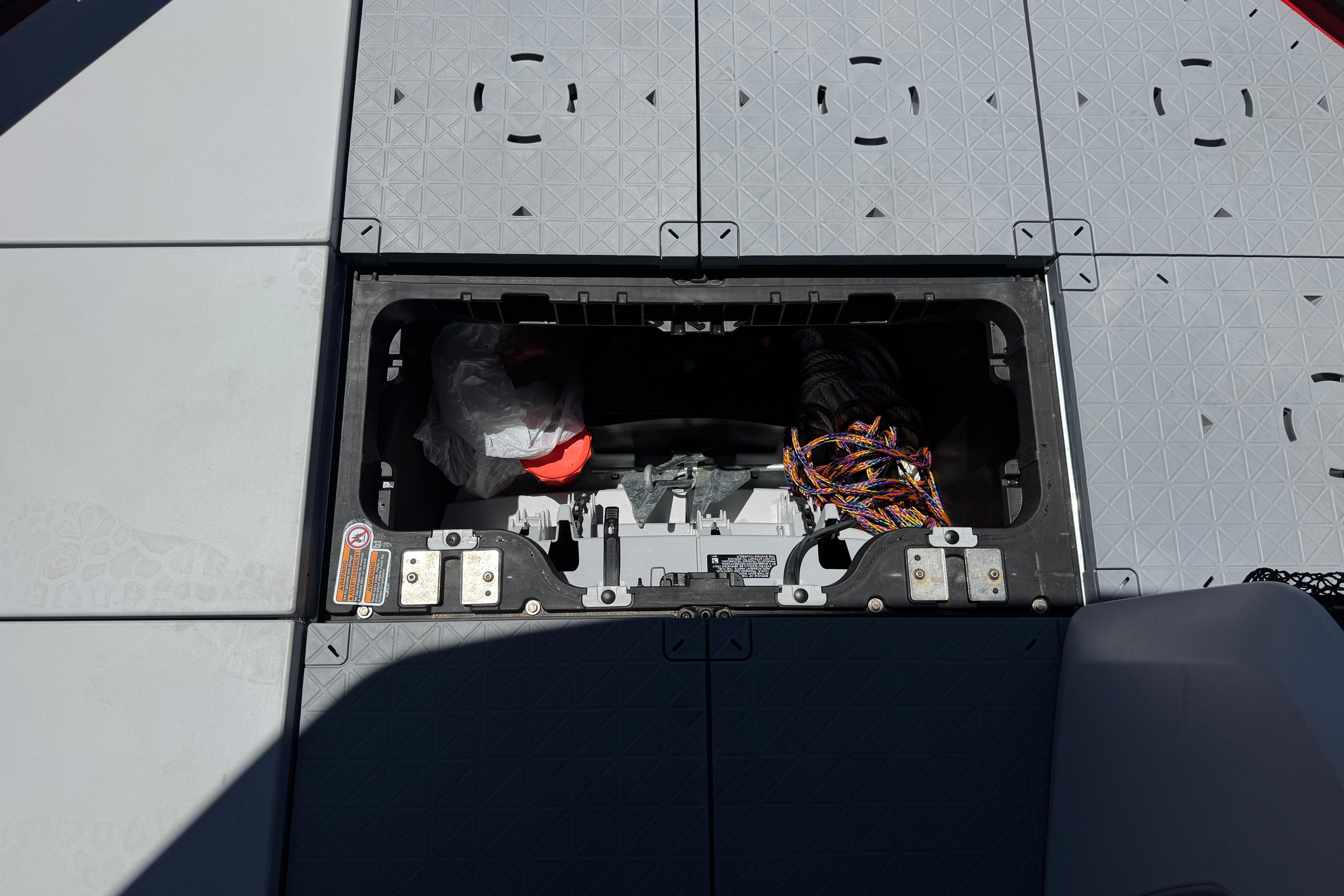 2024 Sea-Doo Switch Compact storage compartment with wiring and equipment visible.