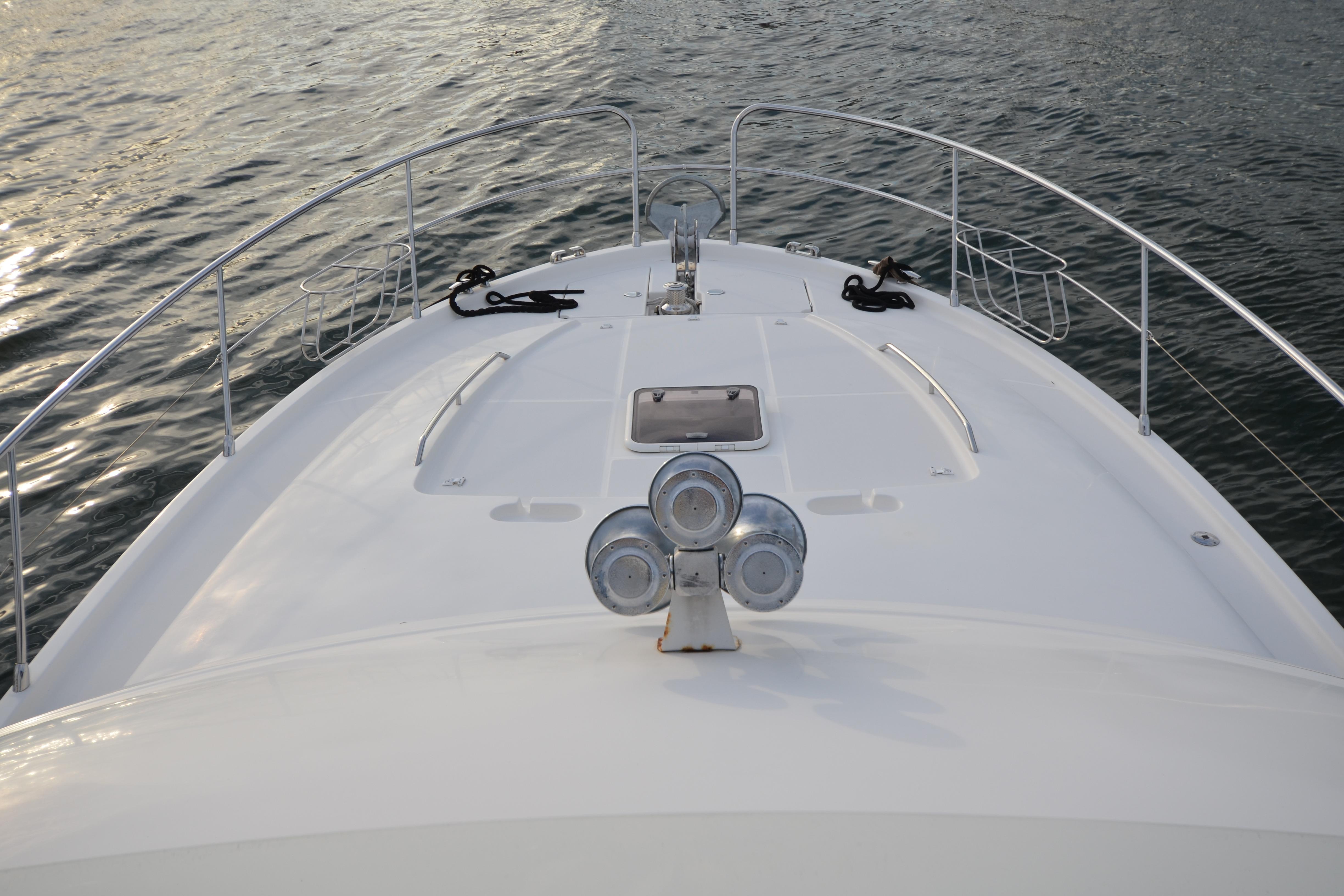 Bow view of 2007 Jeanneau Prestige 46 yacht on calm water.