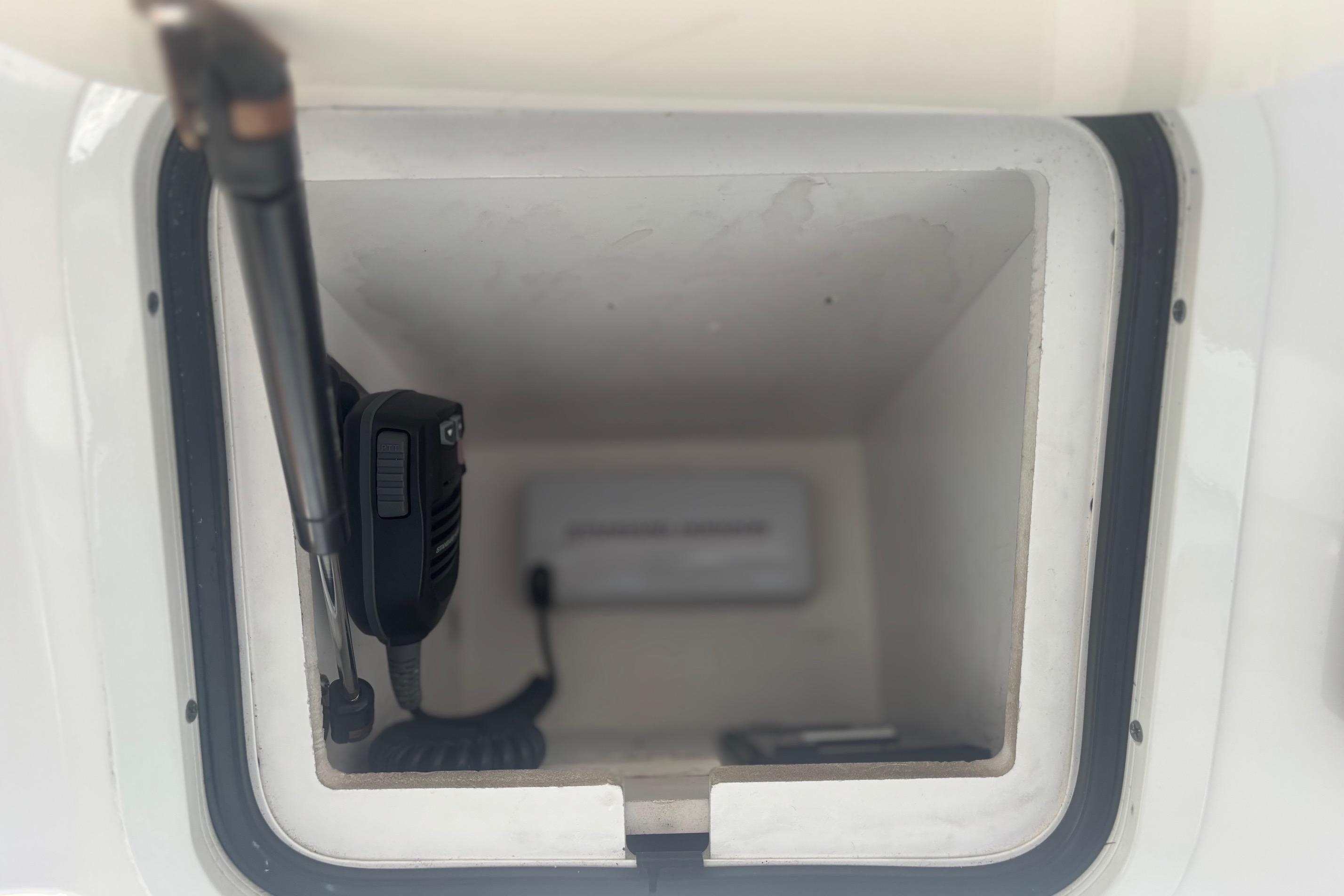 Storage compartment with radio equipment on a 2006 Sea Ray 52 Sedan Bridge.