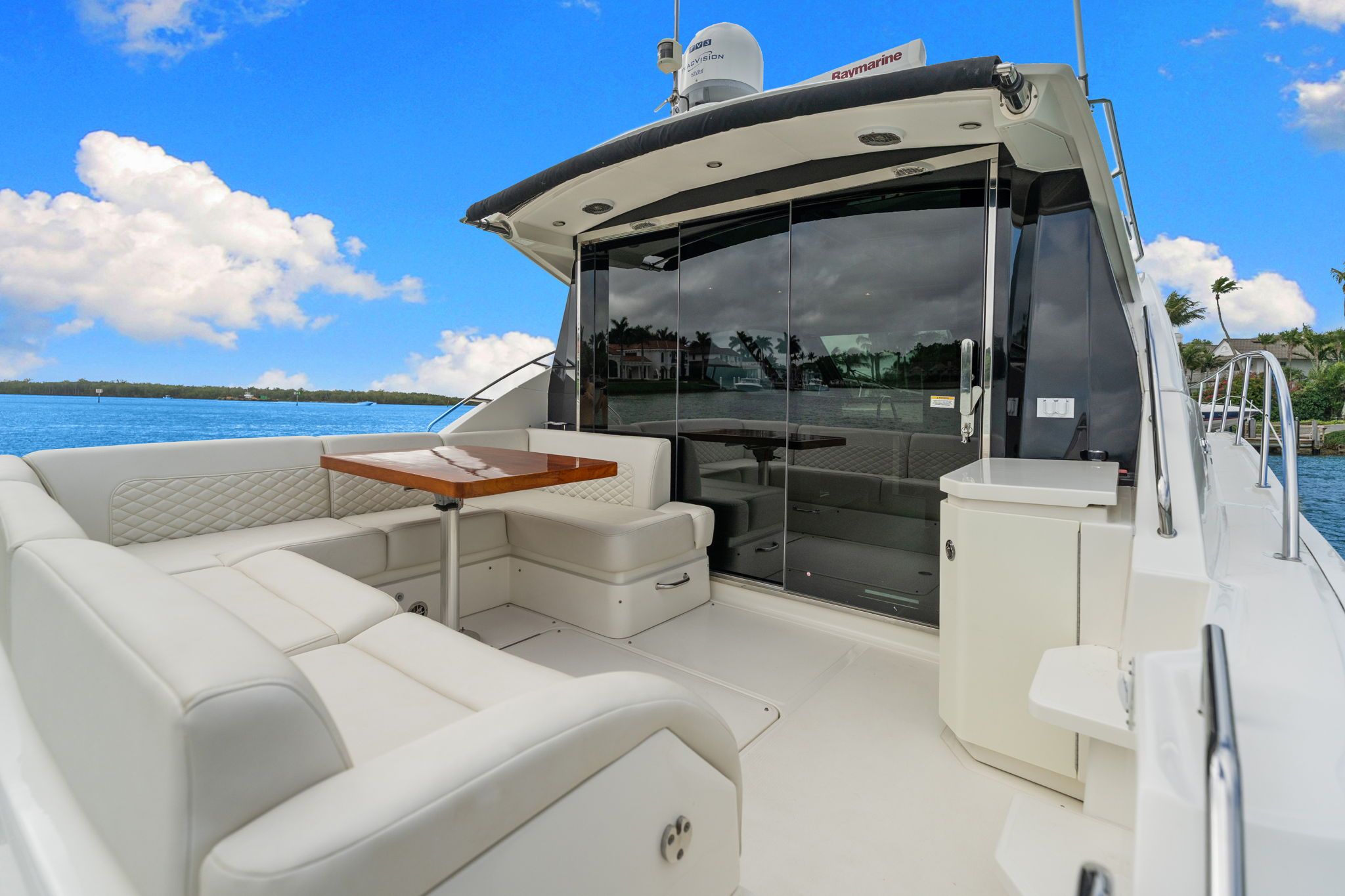 2017 Sea Ray Sundancer 510 with elegant seating area and table on the deck.