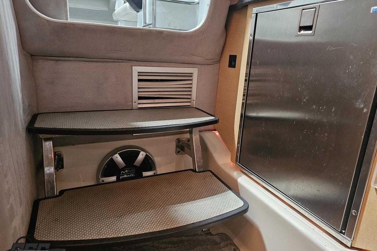 Interior of a 2008 Baja 335 Performance boat with steps and a Polk Audio speaker.