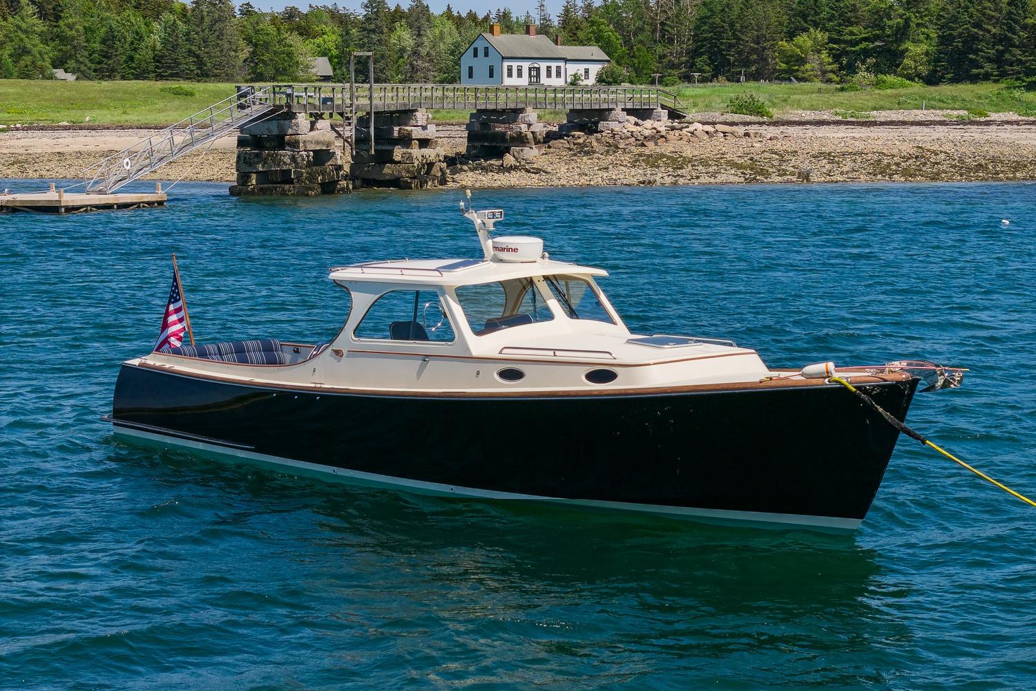 2001 Hinckley Picnic Boat 36 Classic anchored in scenic coastal waters.