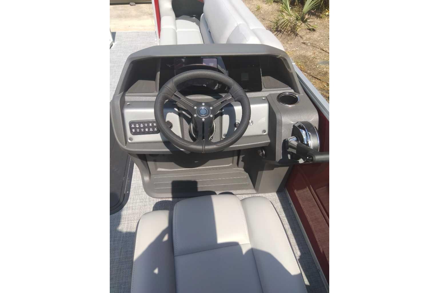 2026 Sun Tracker Party Barge 22 XP3 steering console with modern controls and seating.
