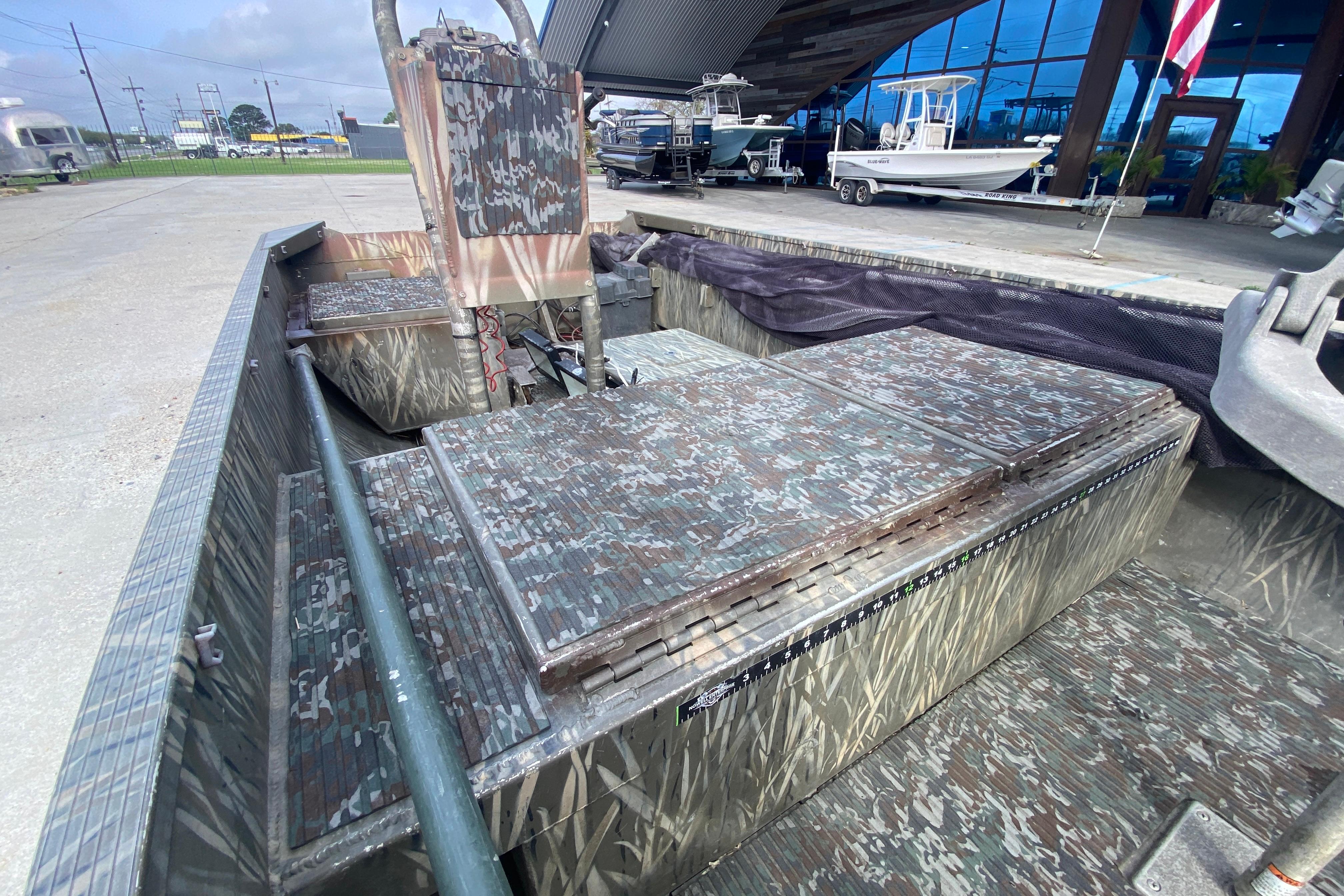 2009 Gator Trax MUD BUDDY 17 X 50 boat with camouflage interior design.