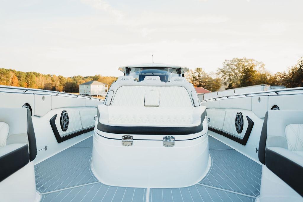 Luxurious 2018 MTI 57 yacht interior with sleek white seating and modern design.