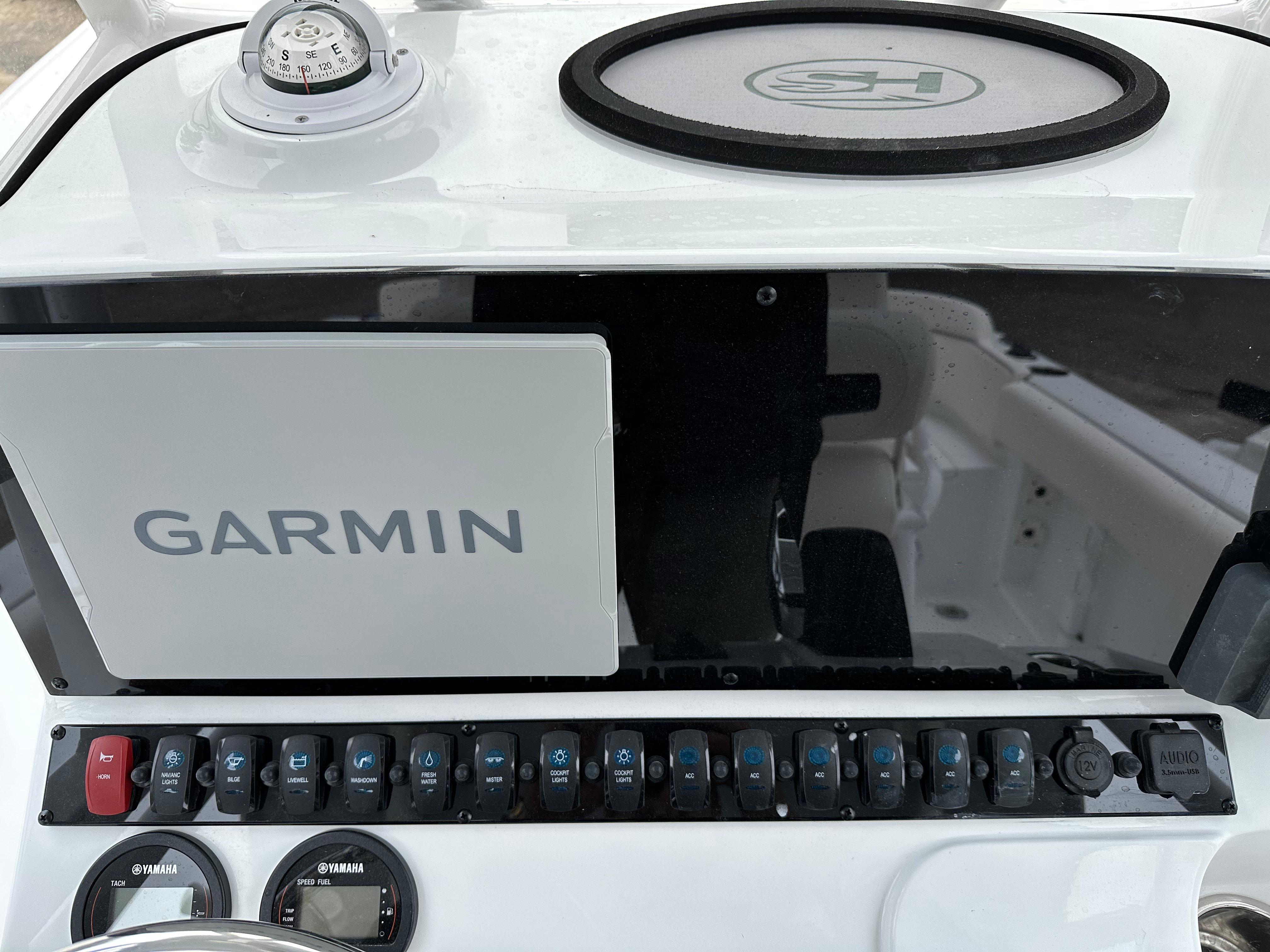 2025 Sea Hunt Ultra 229 dashboard with Garmin navigation system and control panel.