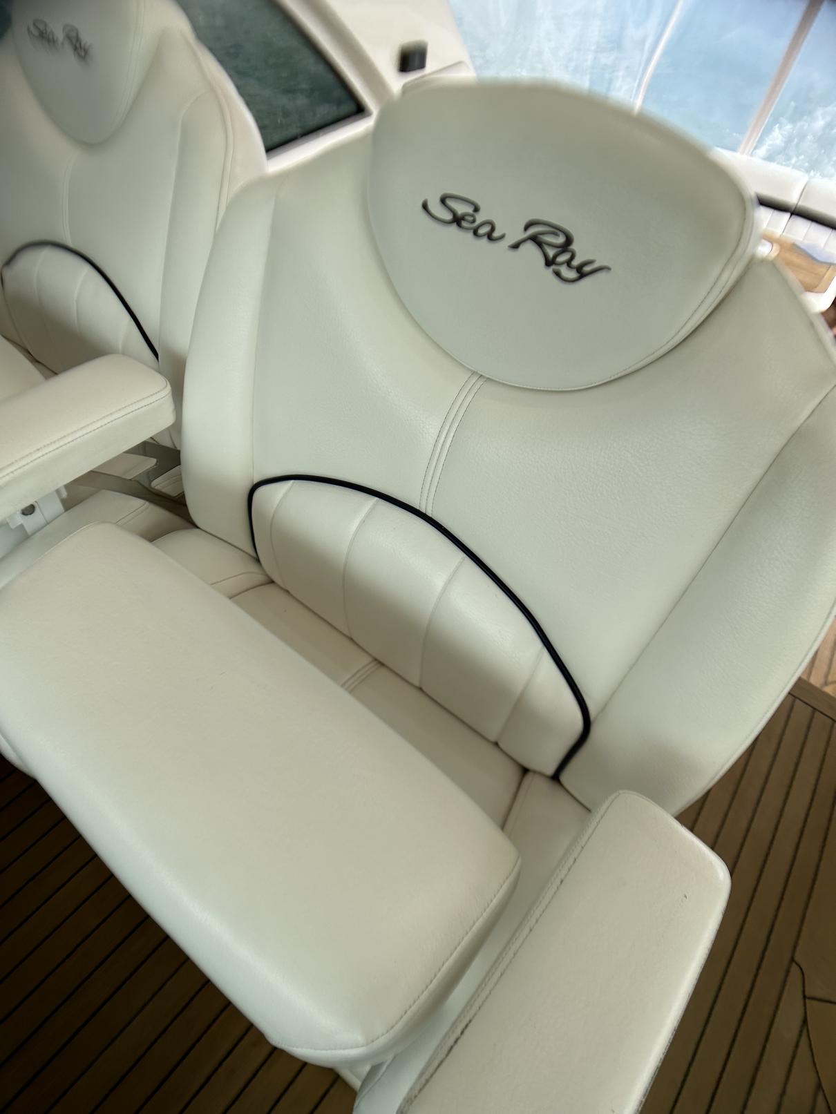 Luxury seating on 2008 Sea Ray 480 Sundancer yacht, featuring elegant white upholstery.
