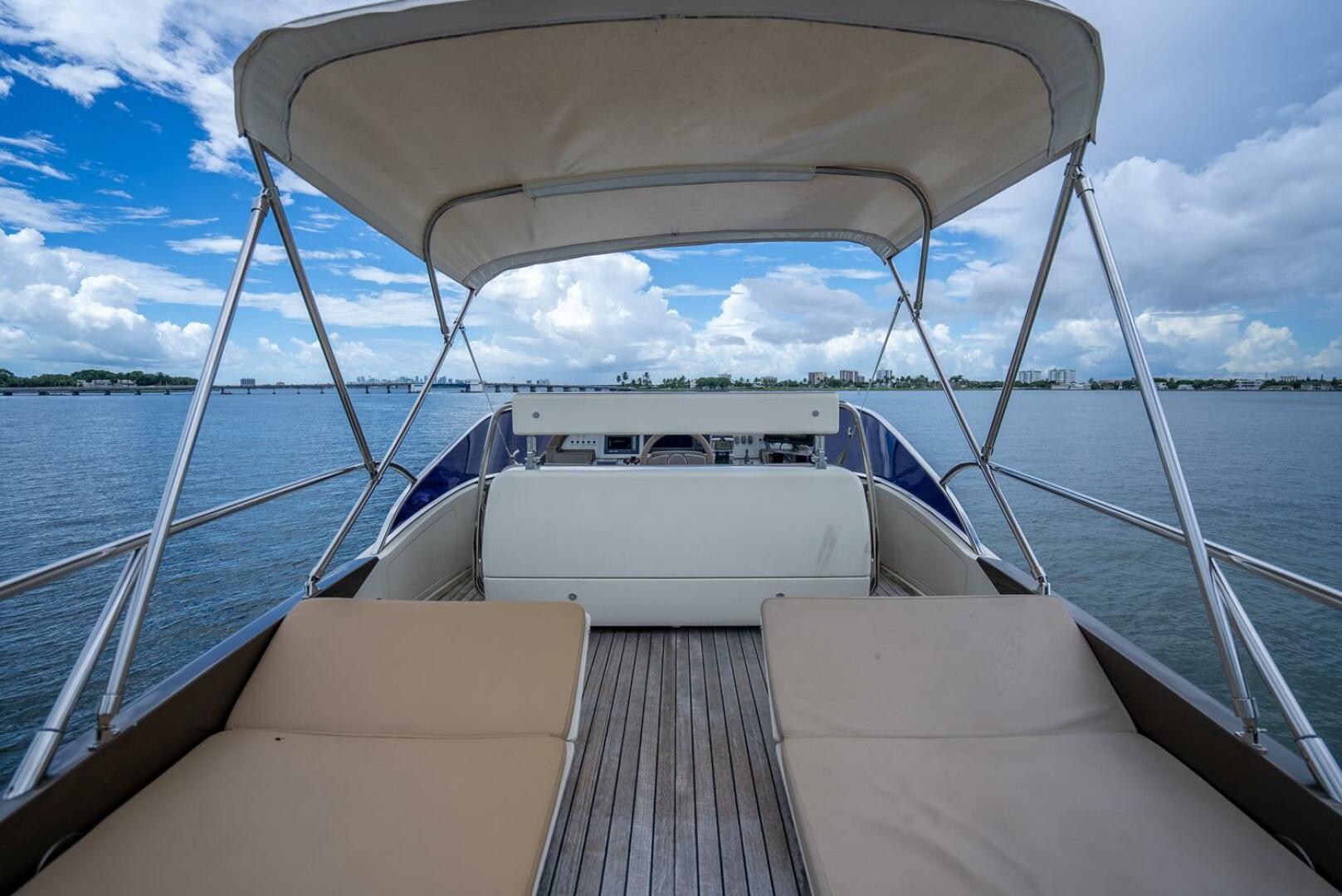 Luxury Riva Sport 56 yacht deck with sun loungers, 2012 model, on calm waters.