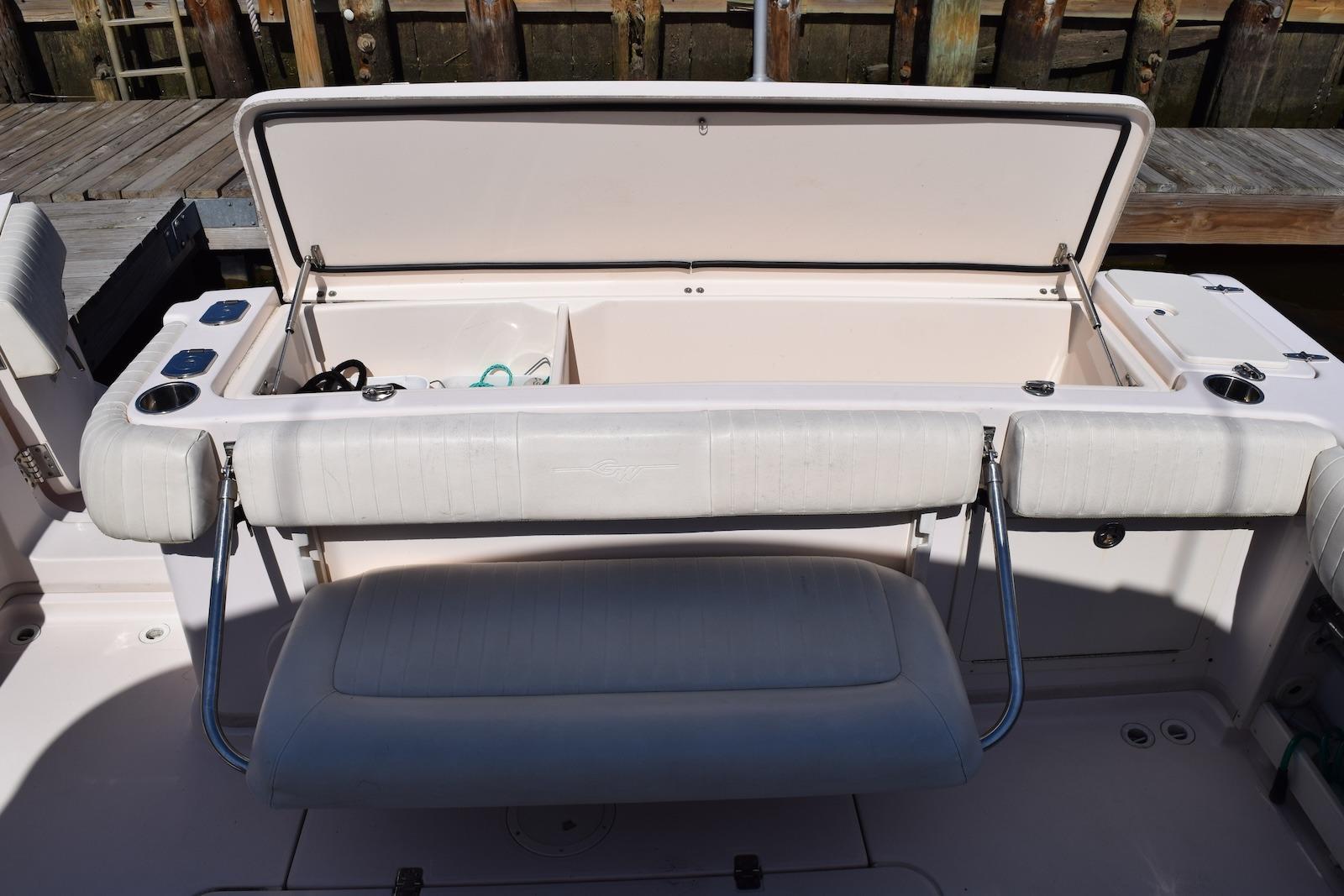2013 Grady-White Express 330 boat with open storage compartment and seating area.