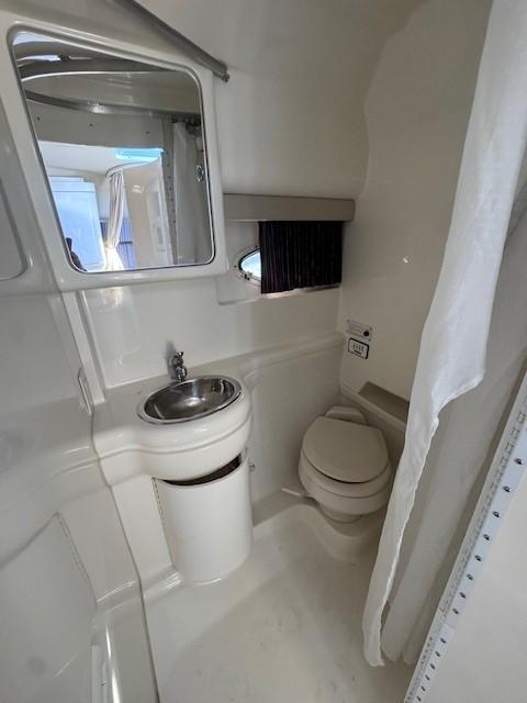 2003 Formula 27 PC boat bathroom with sink, toilet, and mirror.