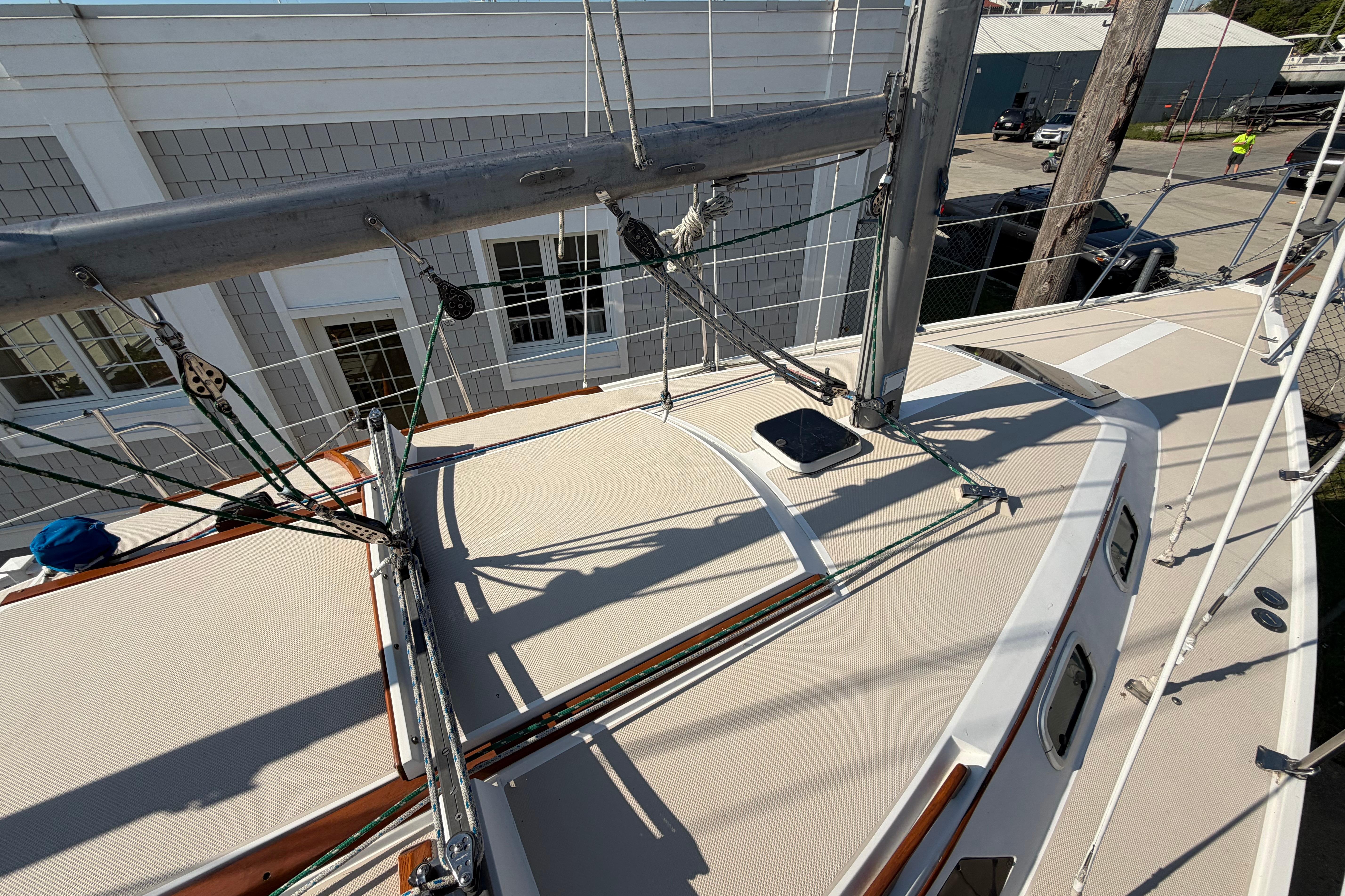 1988 Catalina 30 MkII sailboat deck with rigging and mast, docked near buildings.