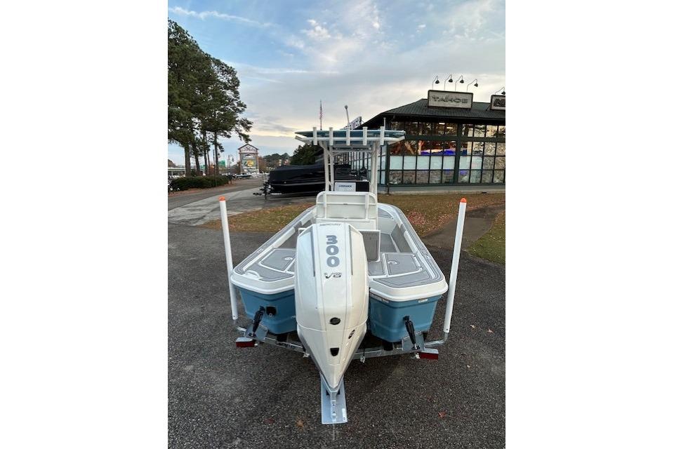 2025 Mako 24 APEX boat with 300 V8 engine, parked outdoors near dealership.