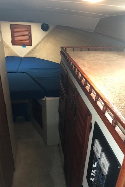 1978 Tollycraft 34 Sedan interior with wood paneling and blue upholstery.