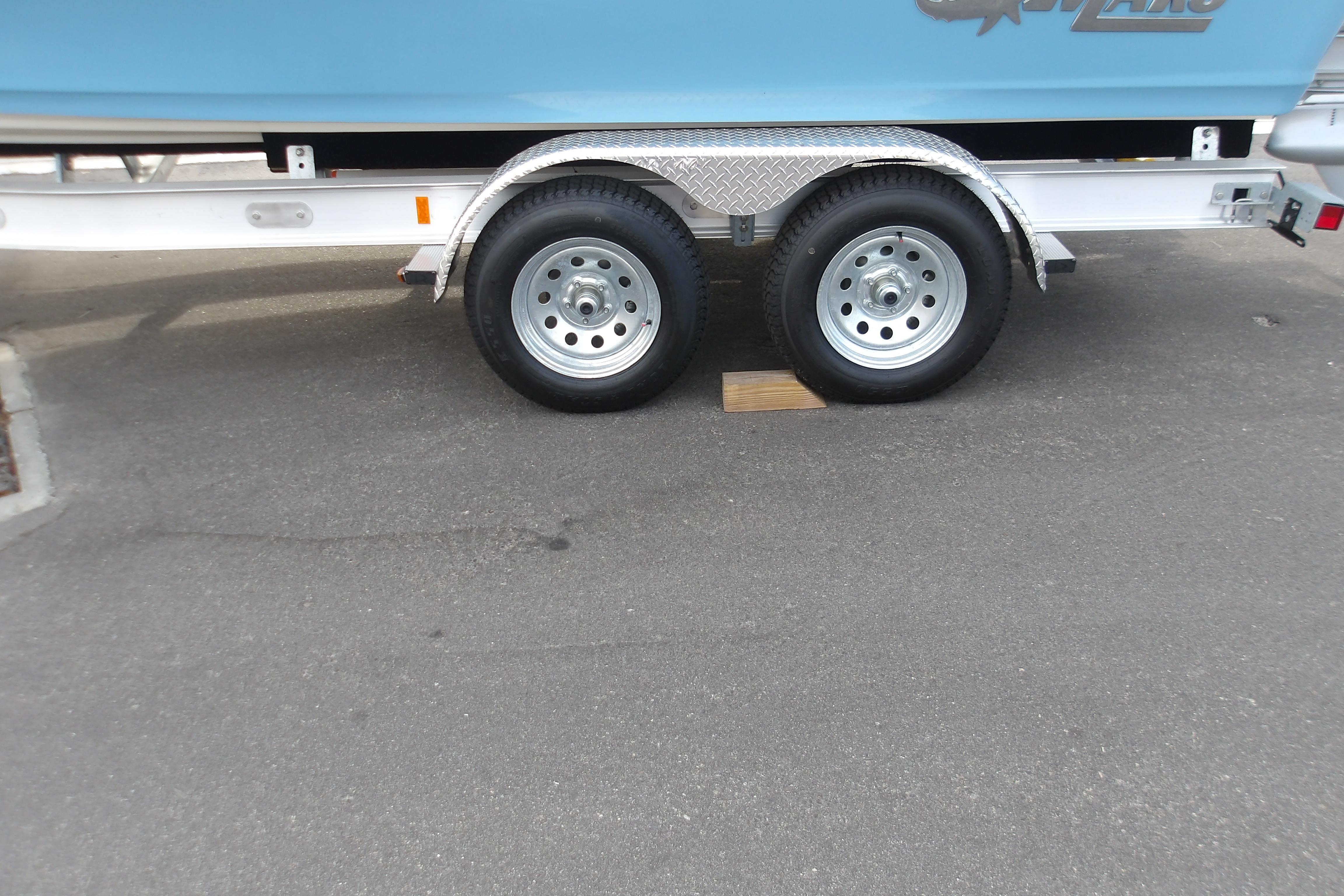 2026 Mako 24 APEX trailer with dual wheels on pavement.