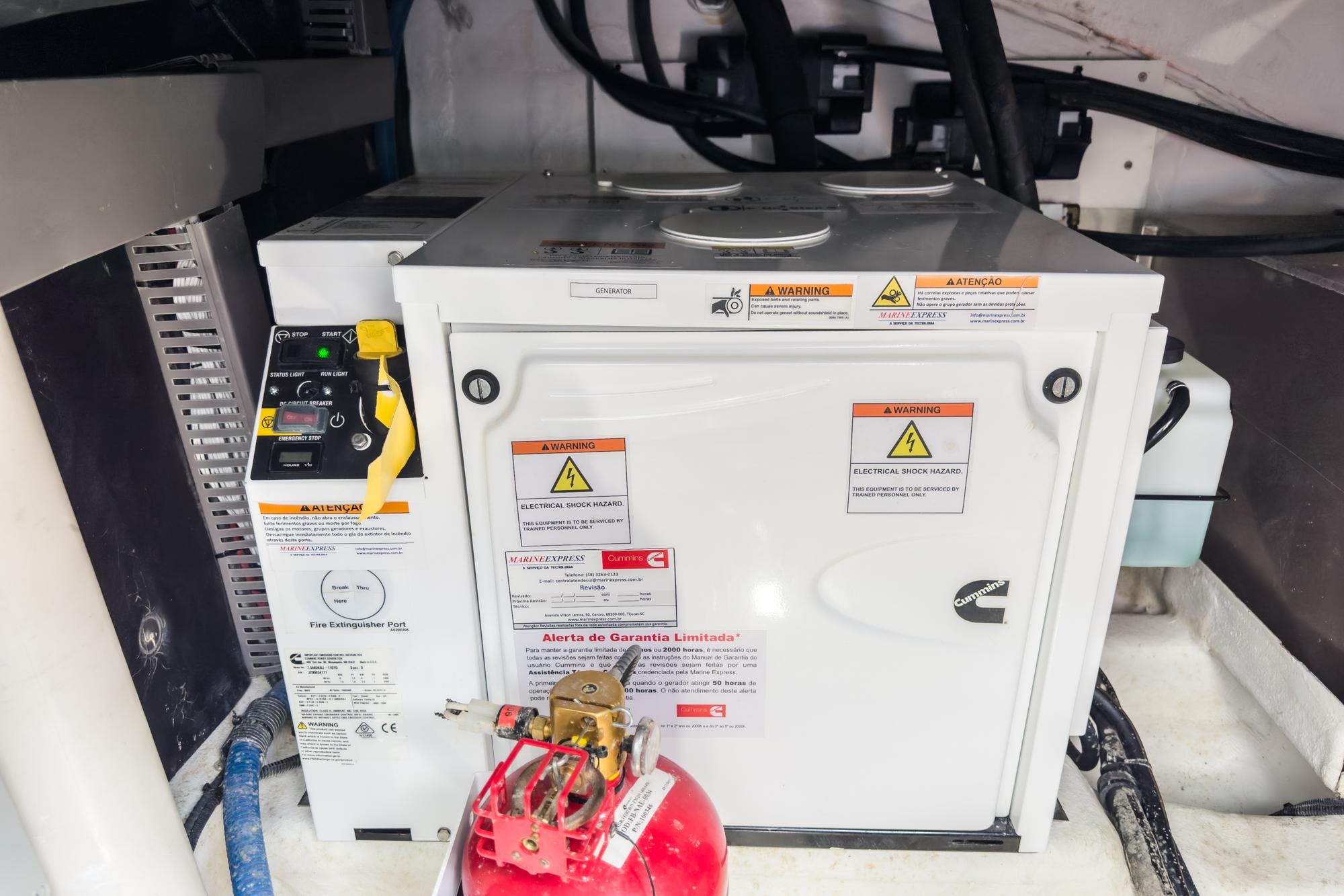Electrical equipment in a Schaefer 400 yacht, 2021 model, with safety labels and fire extinguisher.