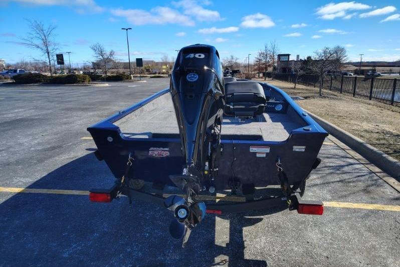 2026 Tracker Super Guide V-16 T boat with outboard motor in parking lot.