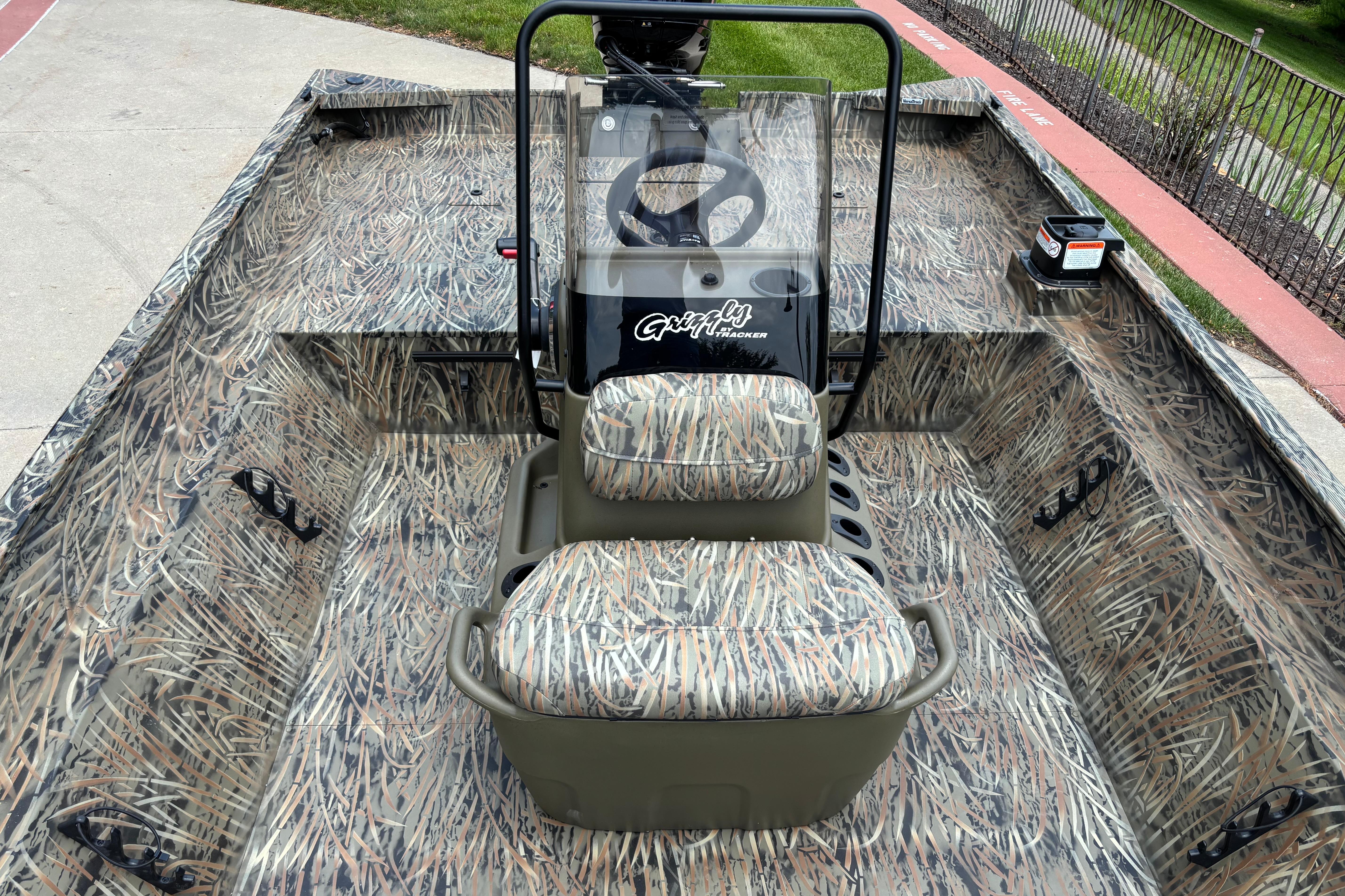 2026 Tracker Grizzly 2072 CC boat with camouflage interior and central steering console.