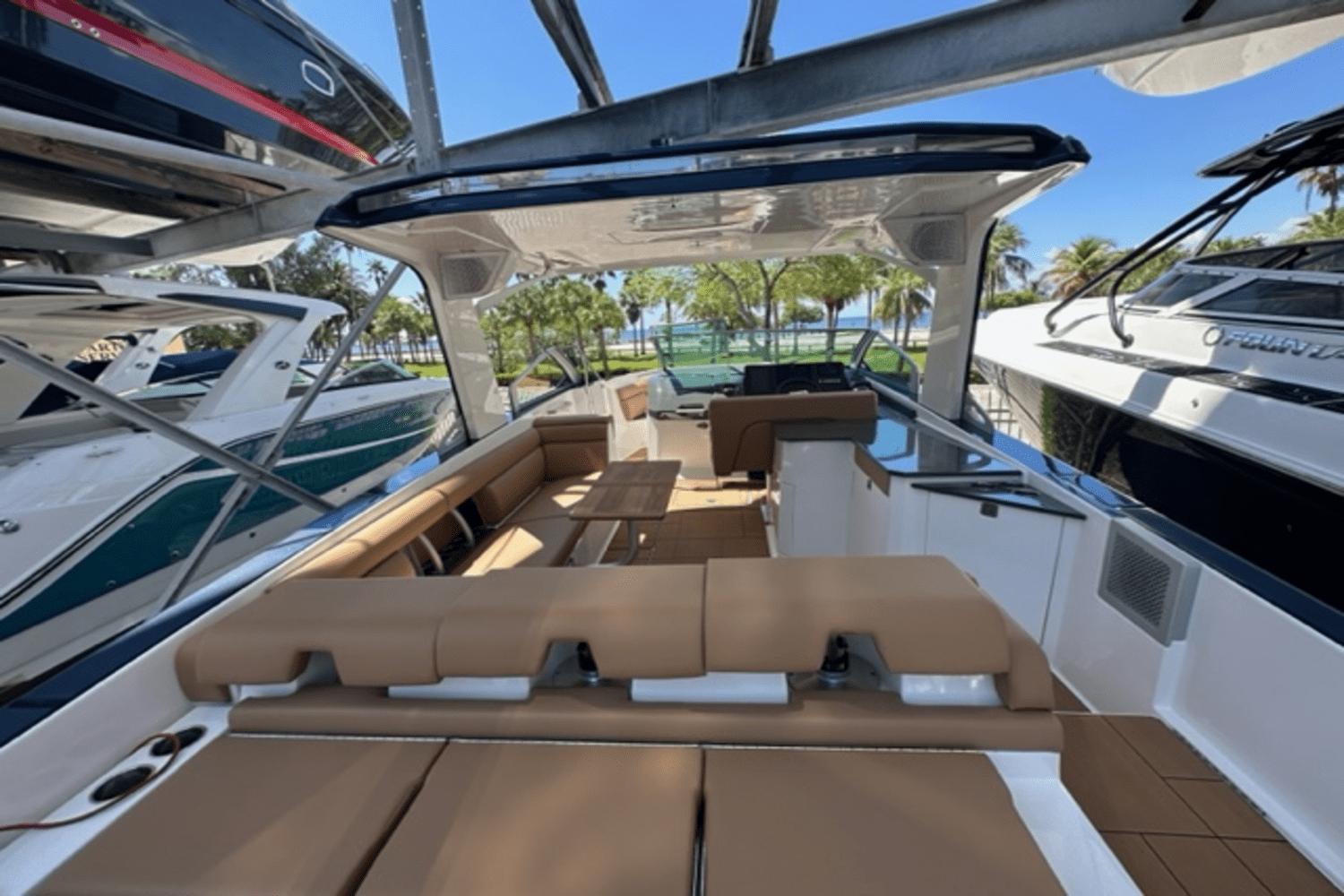 2022 Aviara AV32 Outboard luxury boat interior with tan seating and sleek design.