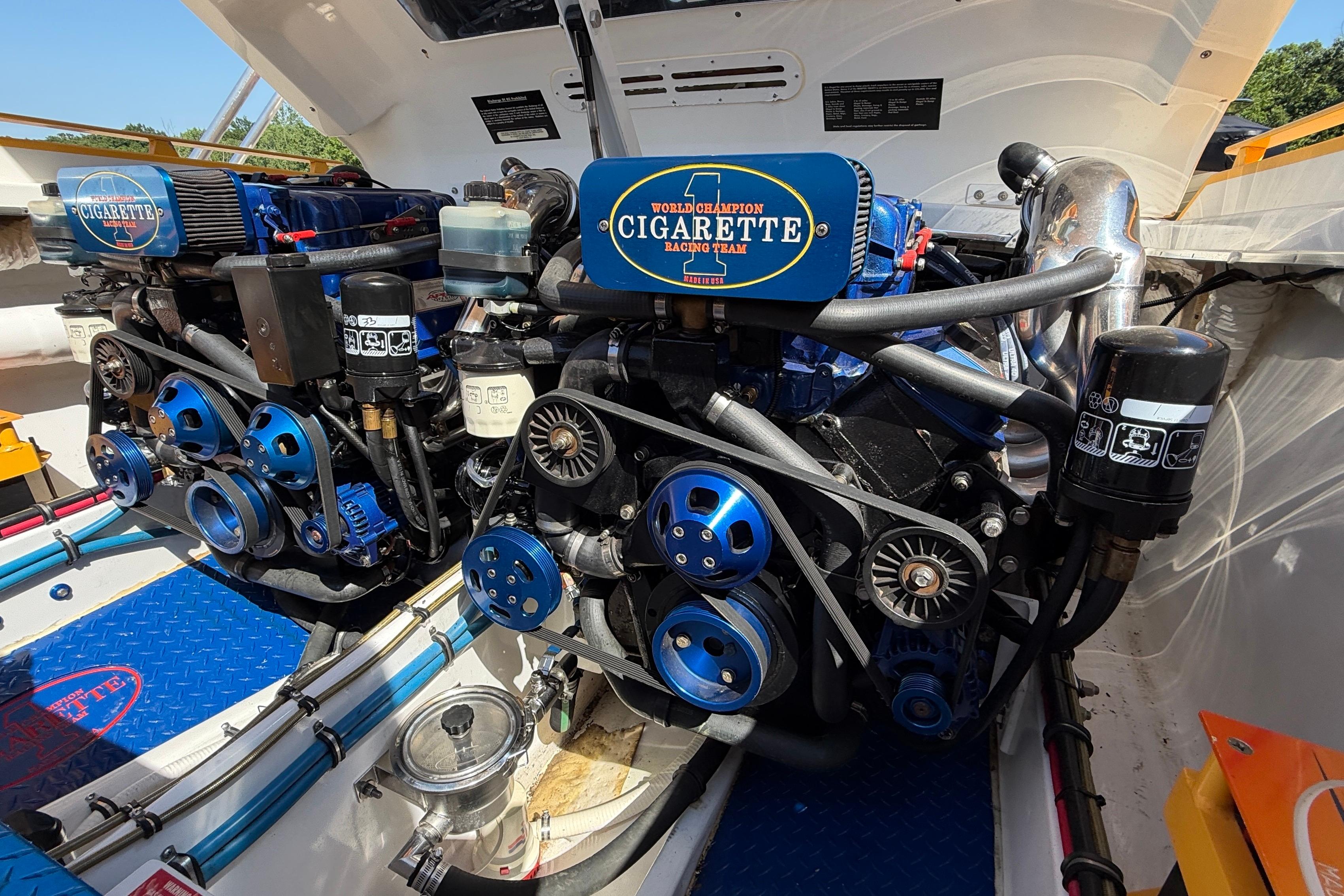 Engine compartment of a 2002 Cigarette 35' Cafe Racer boat, showcasing dual engines.