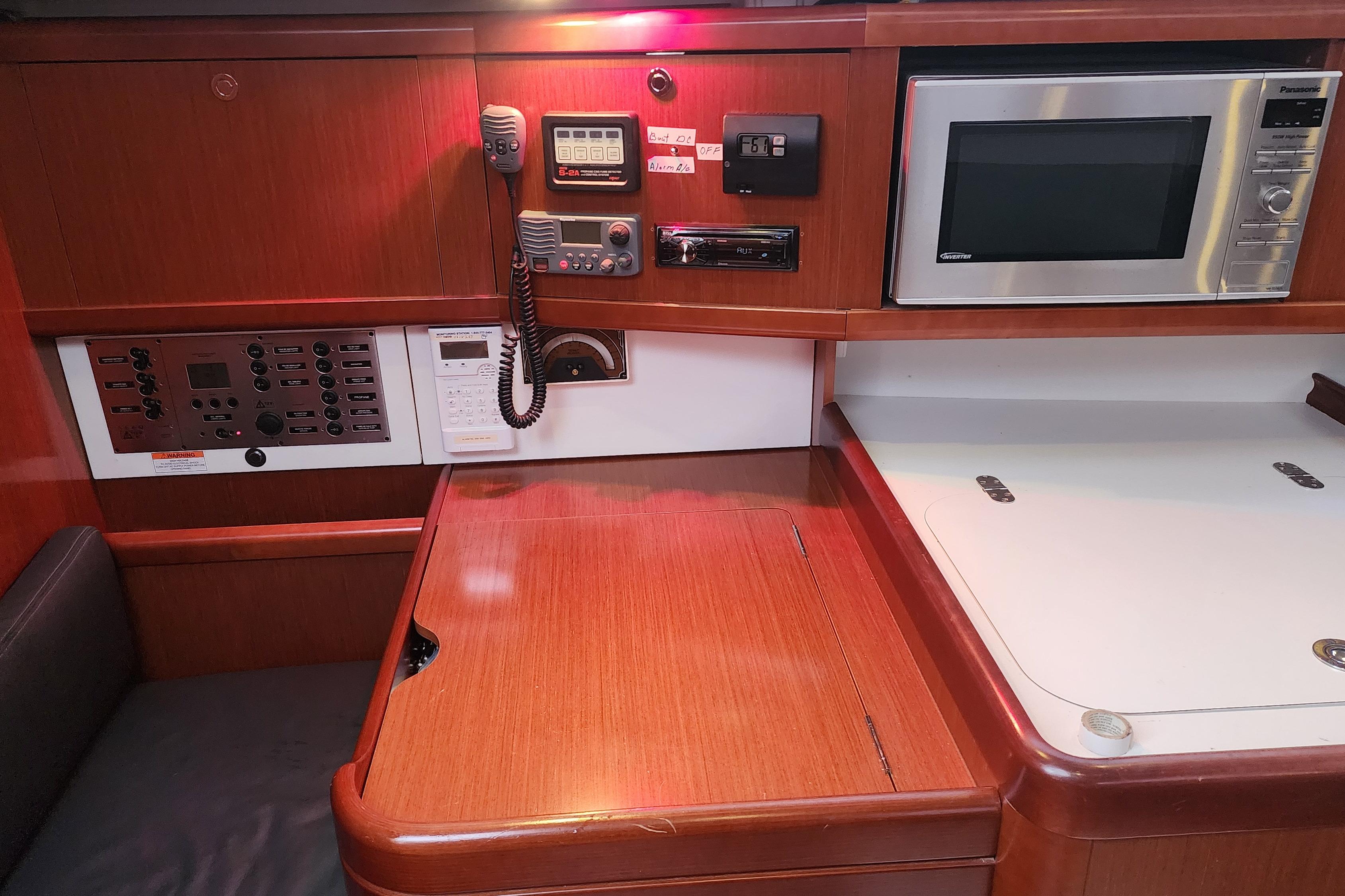 Interior of a 2012 Beneteau 40 yacht with navigation equipment and microwave.