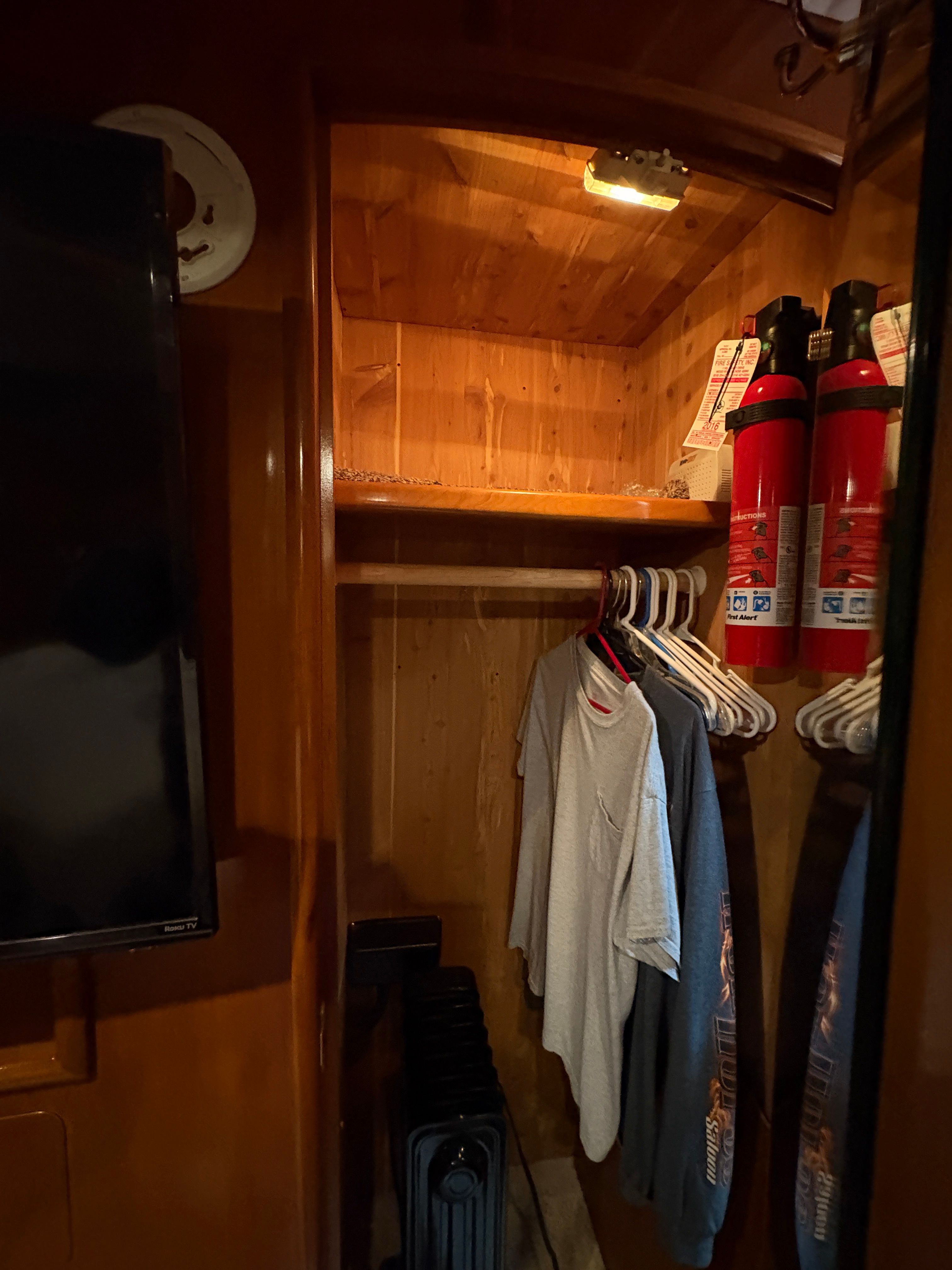 Interior of Carver 530 Voyager Pilothouse with closet and fire extinguishers.