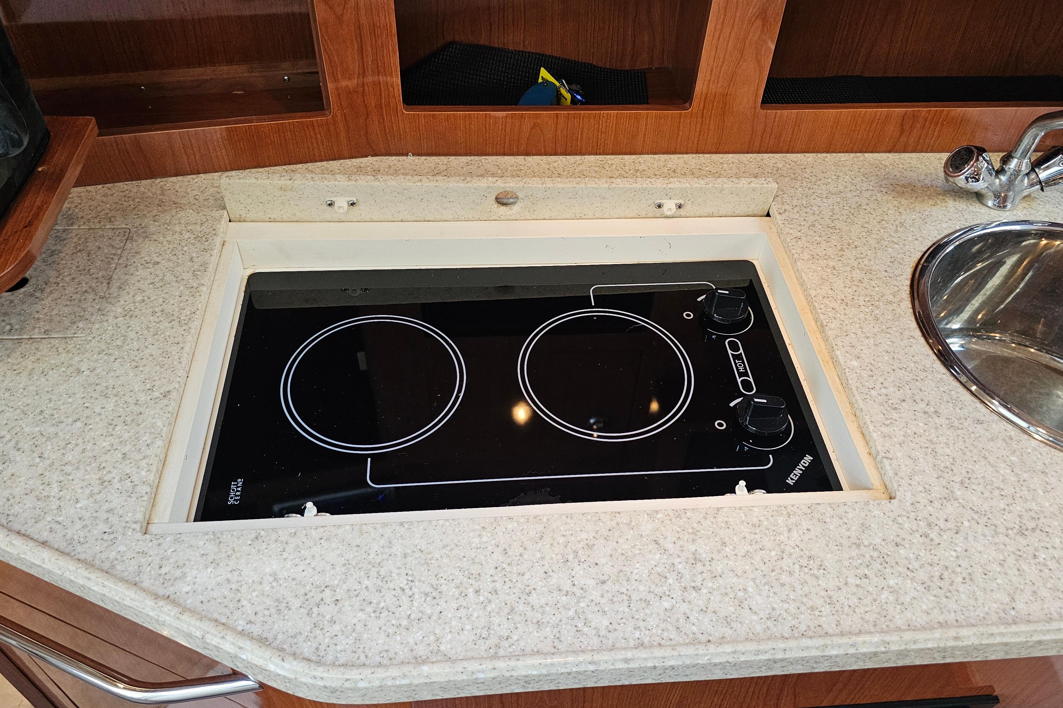 2005 Regal 3060 Window Express boat kitchen with Kenyon electric cooktop and sink.
