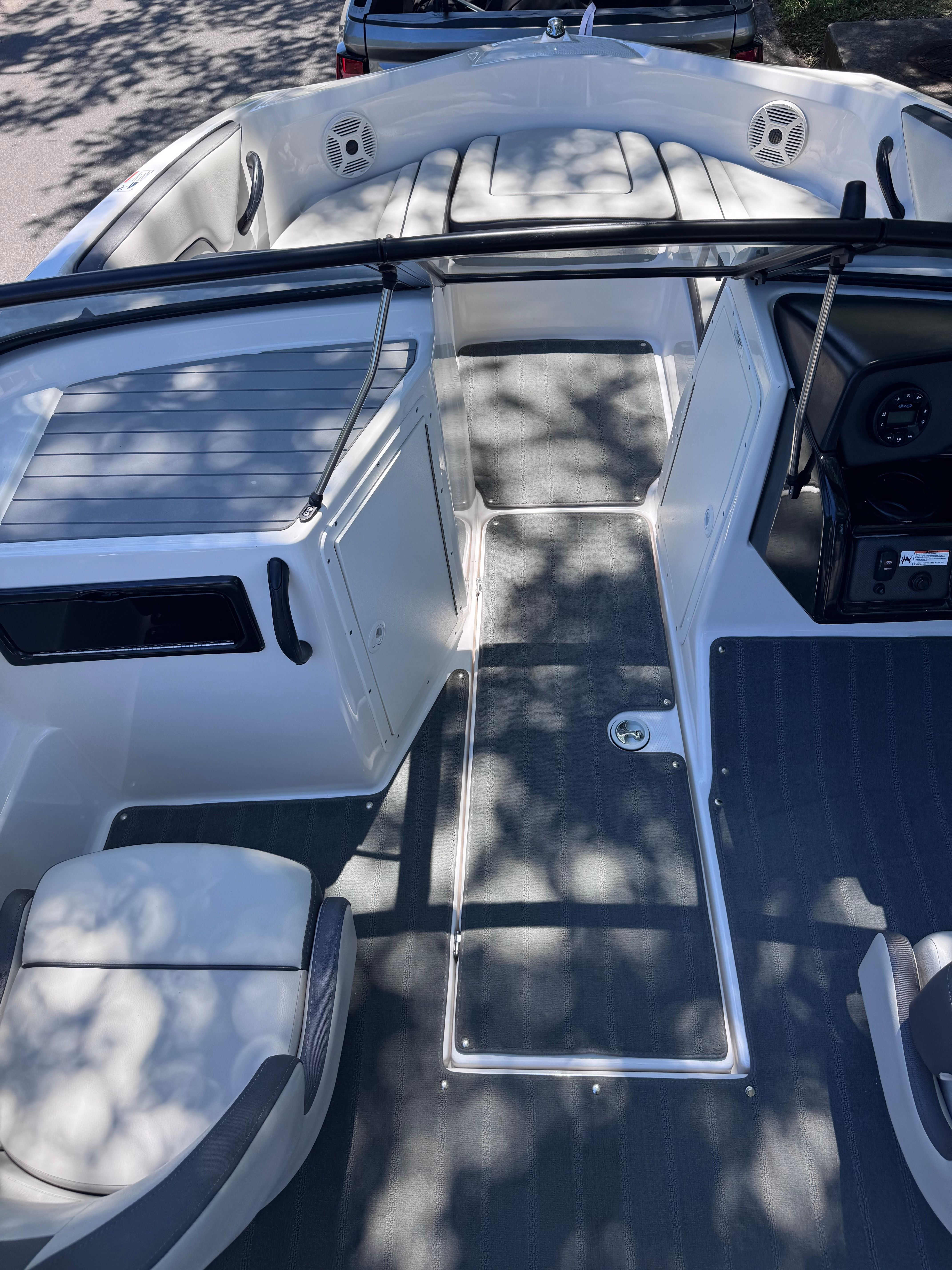 Interior of a 2020 Yamaha SX190 boat, gray upholstery and speakers.