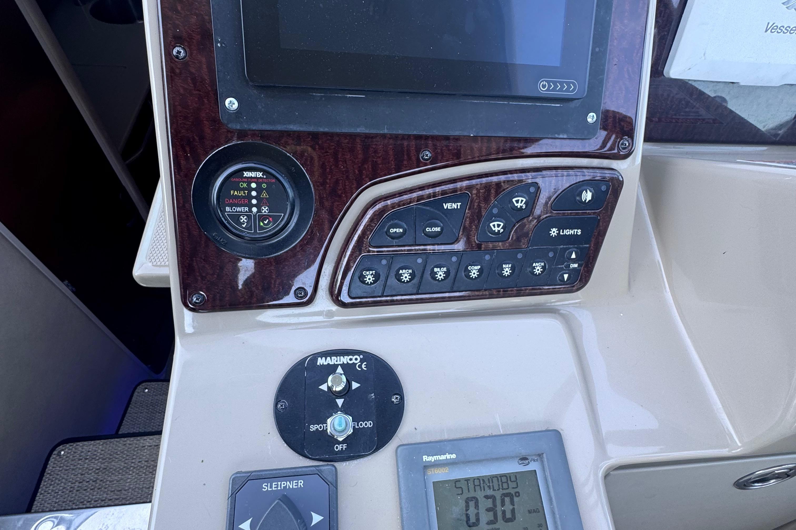 Control panel of a 2008 Sea Ray 350 Sundancer boat with various switches and displays.