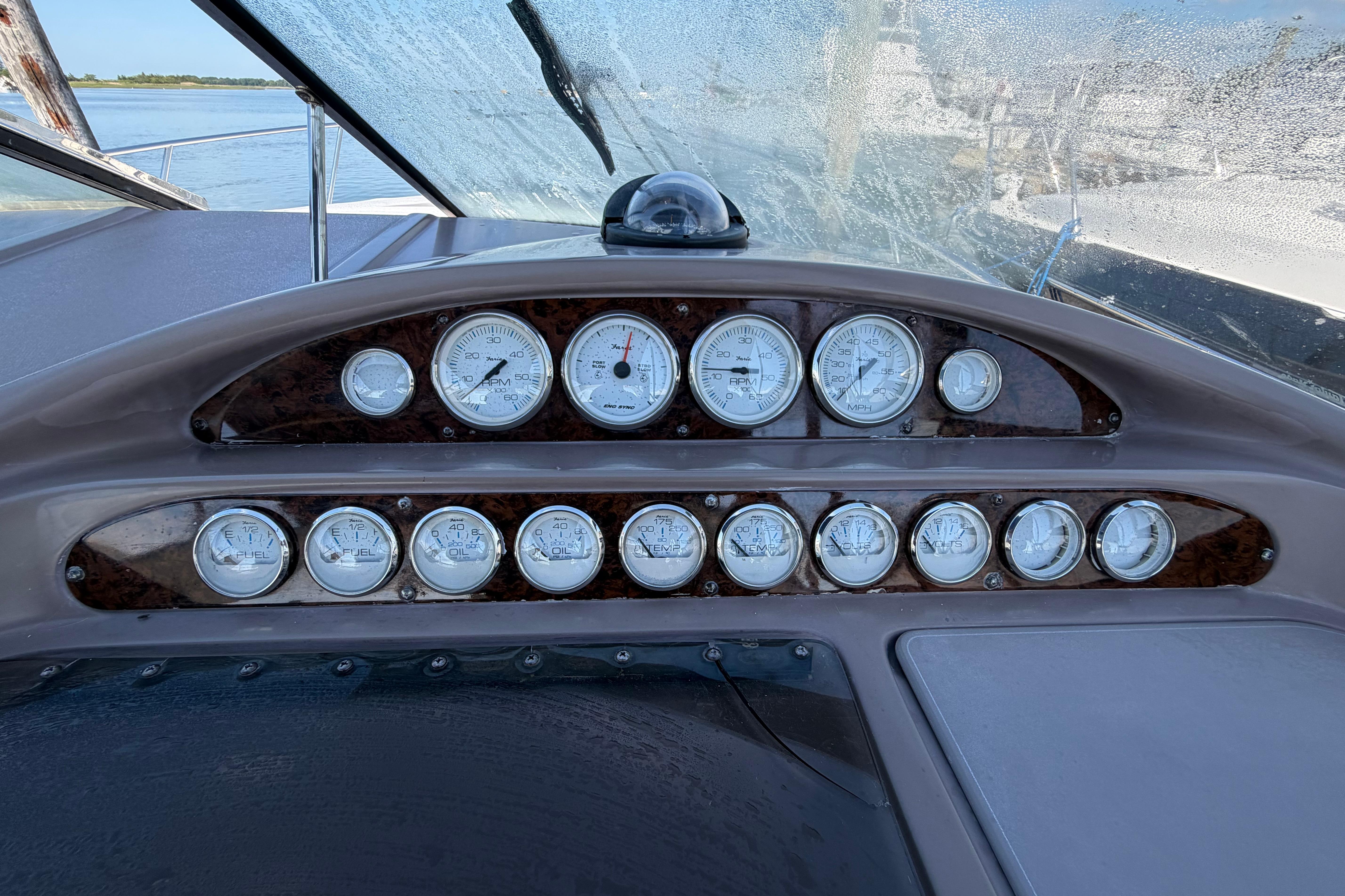Dashboard of a 2003 Regal Commodore 3260 boat with multiple gauges and controls.