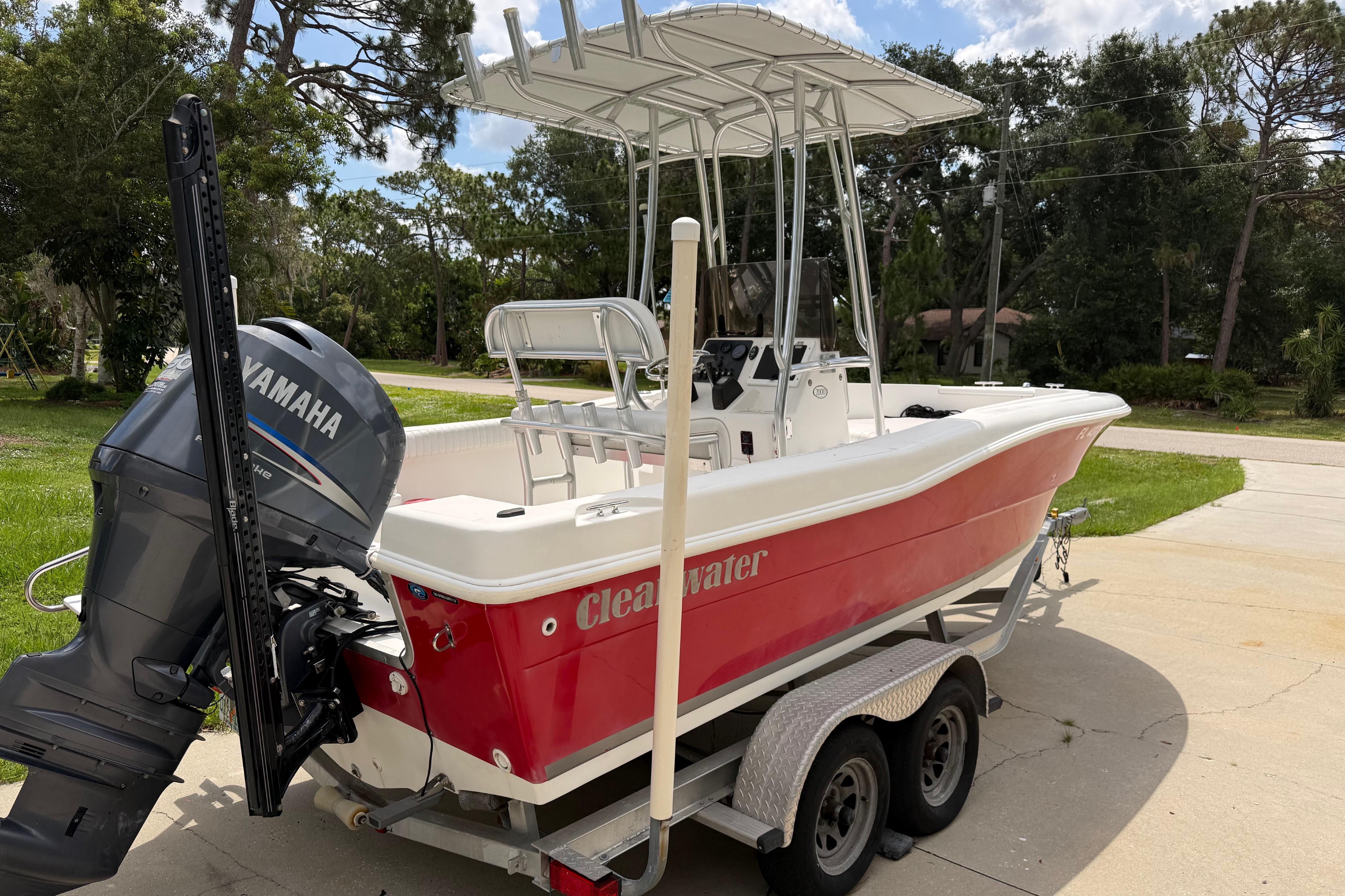 Red 2012 Clearwater 2000 Center Console boat with Yamaha outboard motor on trailer.