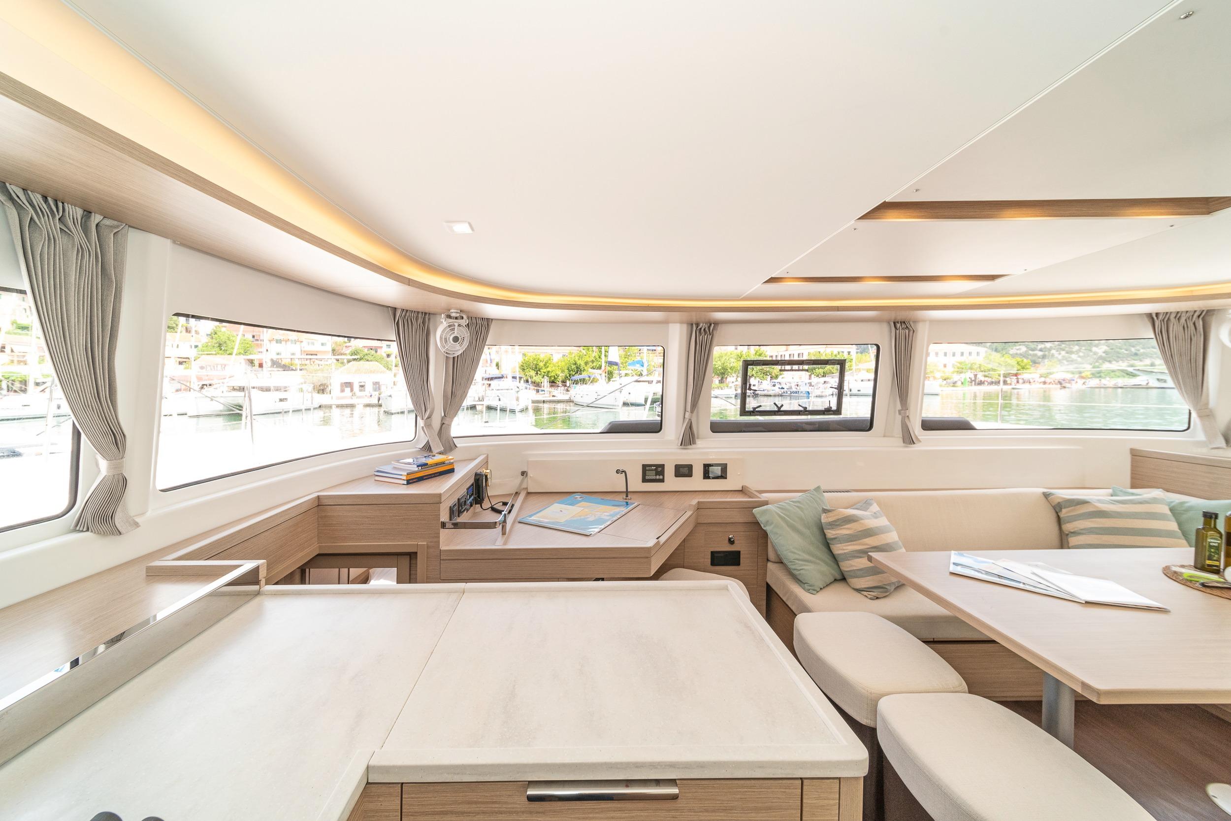 Interior of 2023 Lagoon 46 catamaran, featuring modern design and spacious seating area.