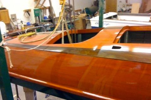 1931 Hacker-Craft 26 Dolphin boat with polished wooden finish in workshop setting.