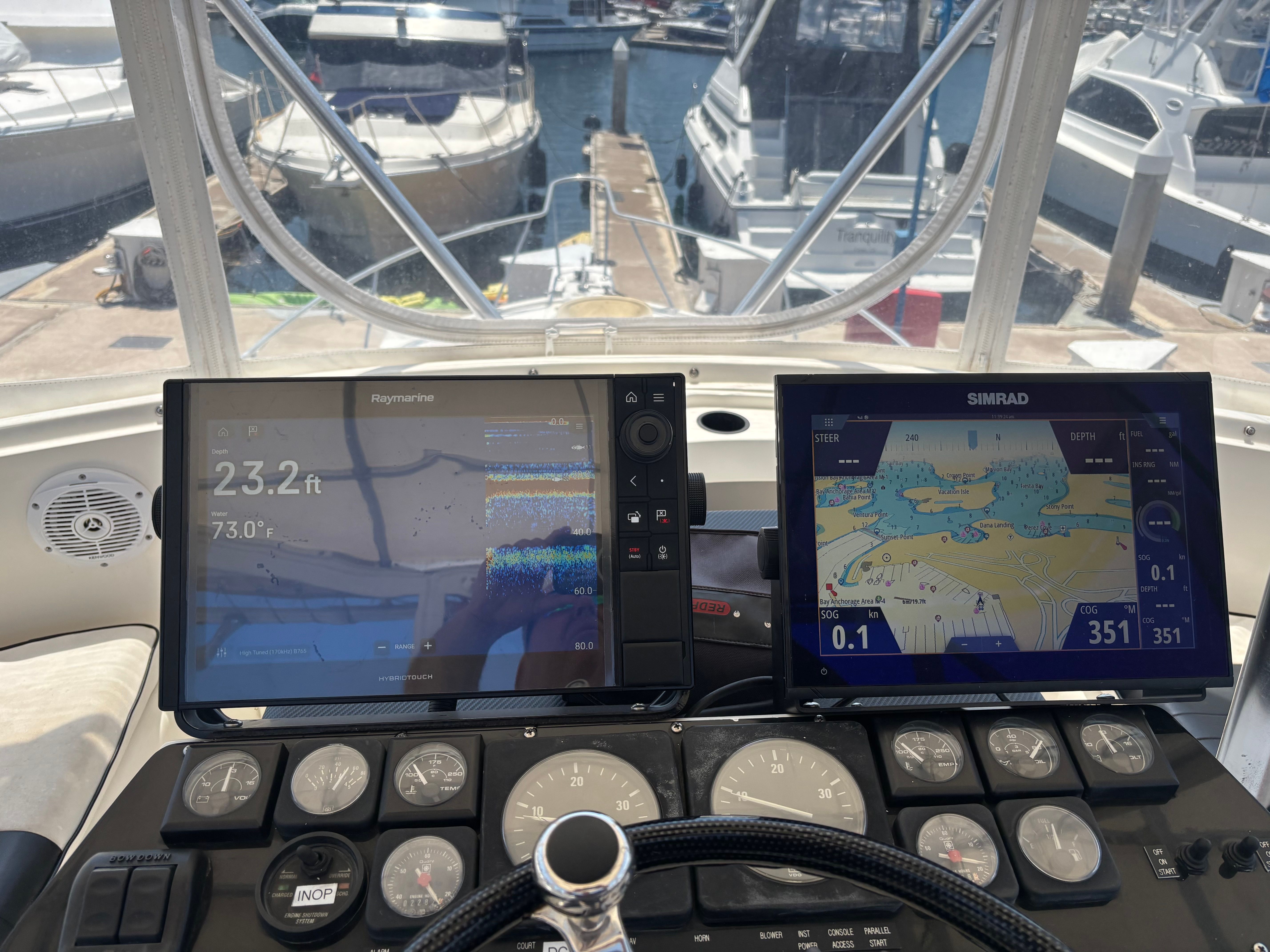 The image shows the cockpit of a 1989 Luhrs 350 Tournament with navigation screens.