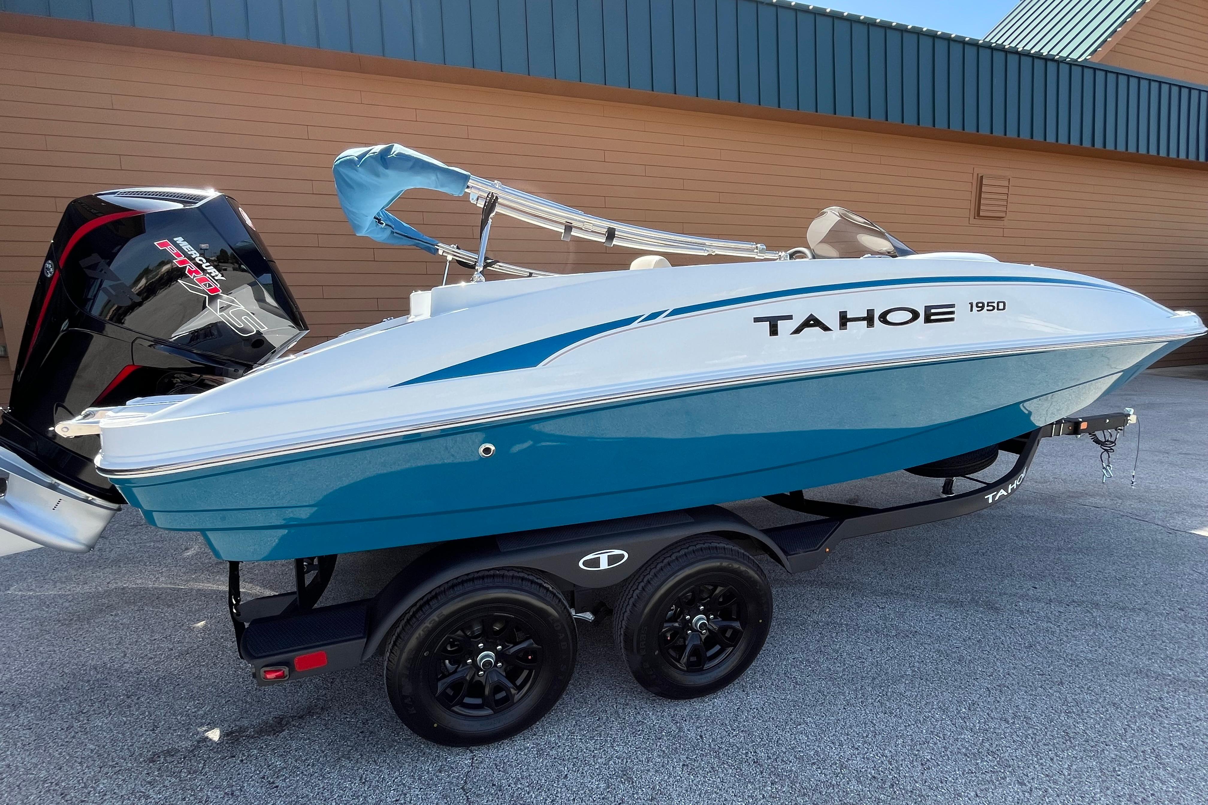 2026 Tahoe 1950 boat on trailer, featuring sleek design and powerful outboard motor.